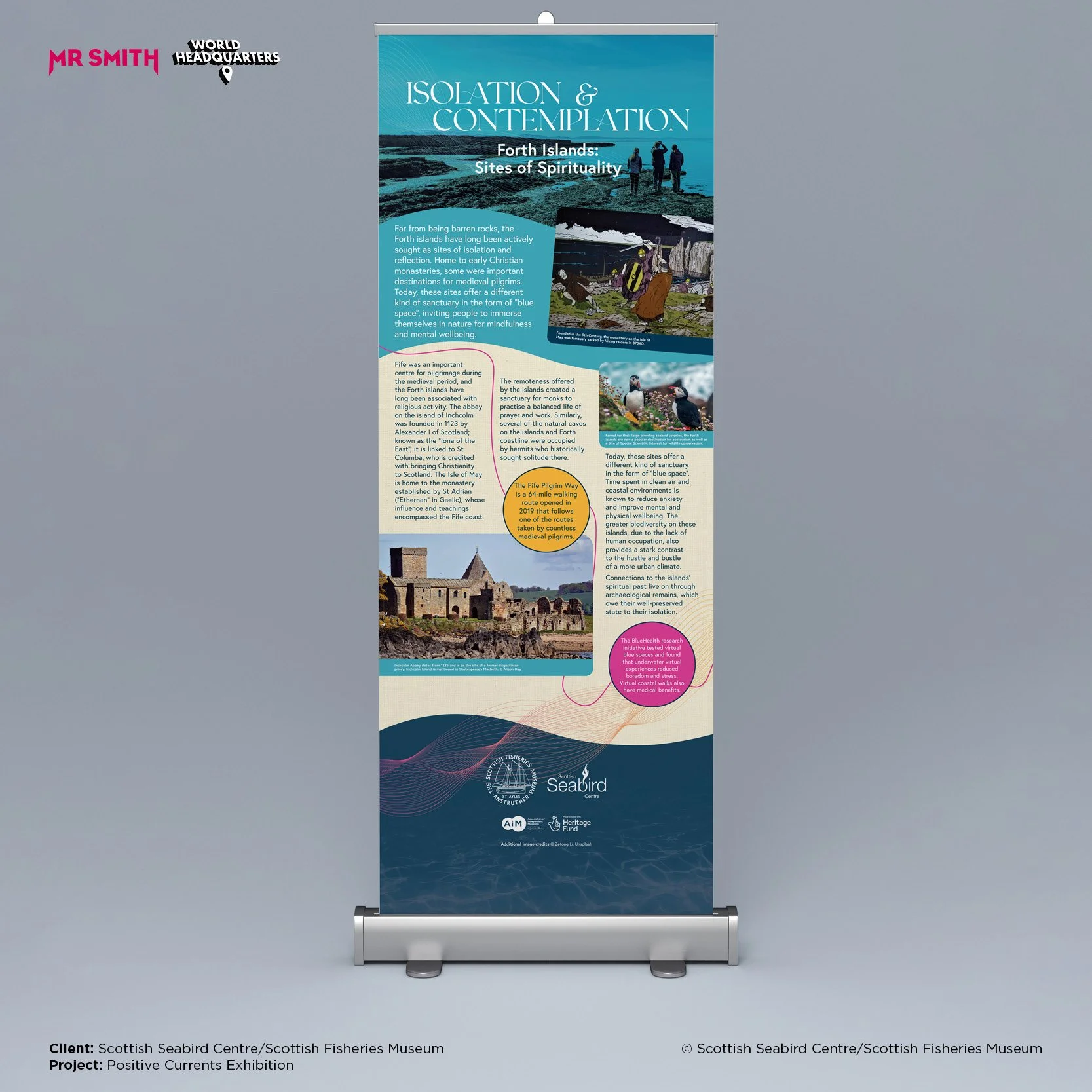 An exhibition banner titled 'Isolation & Contemplation: Forth Islands: Sites of Spirituality' with images of the Forth Islands' landscape, historical sites, wildlife, and text explaining their spiritual and historical significance. The banner include
