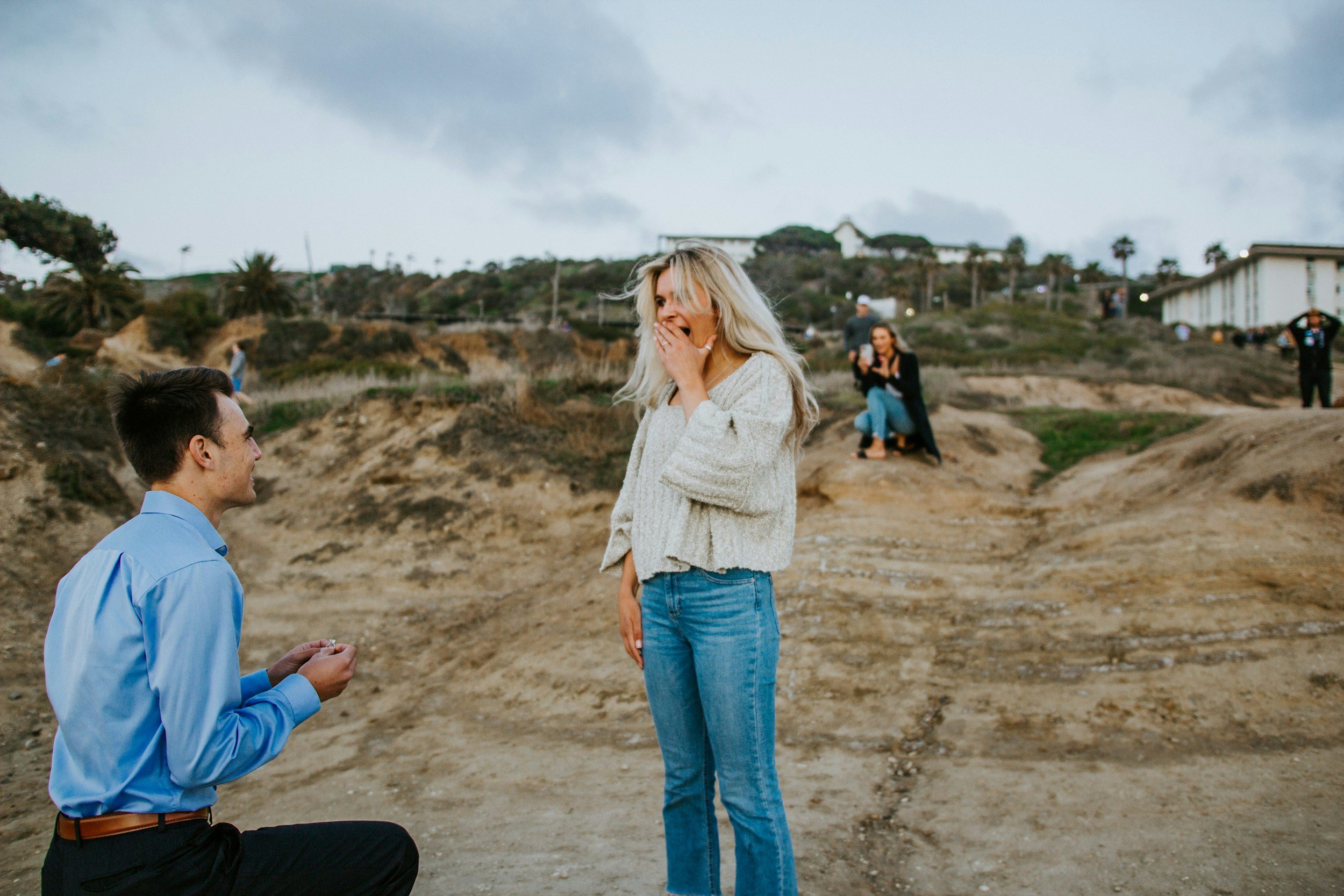A woman reacting with joy to a proposal