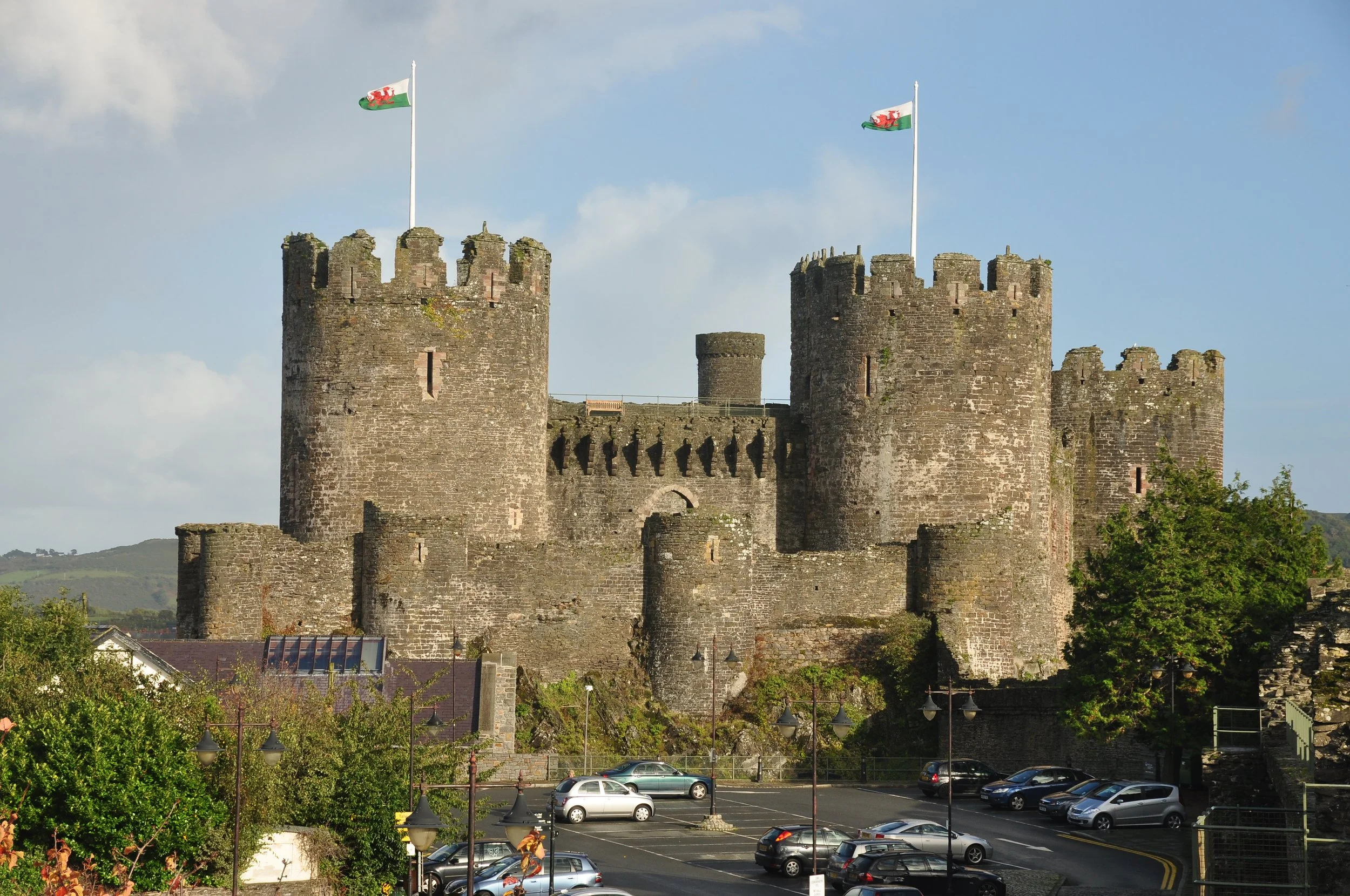 The towers of Conwy Castle with Welsh flags flying