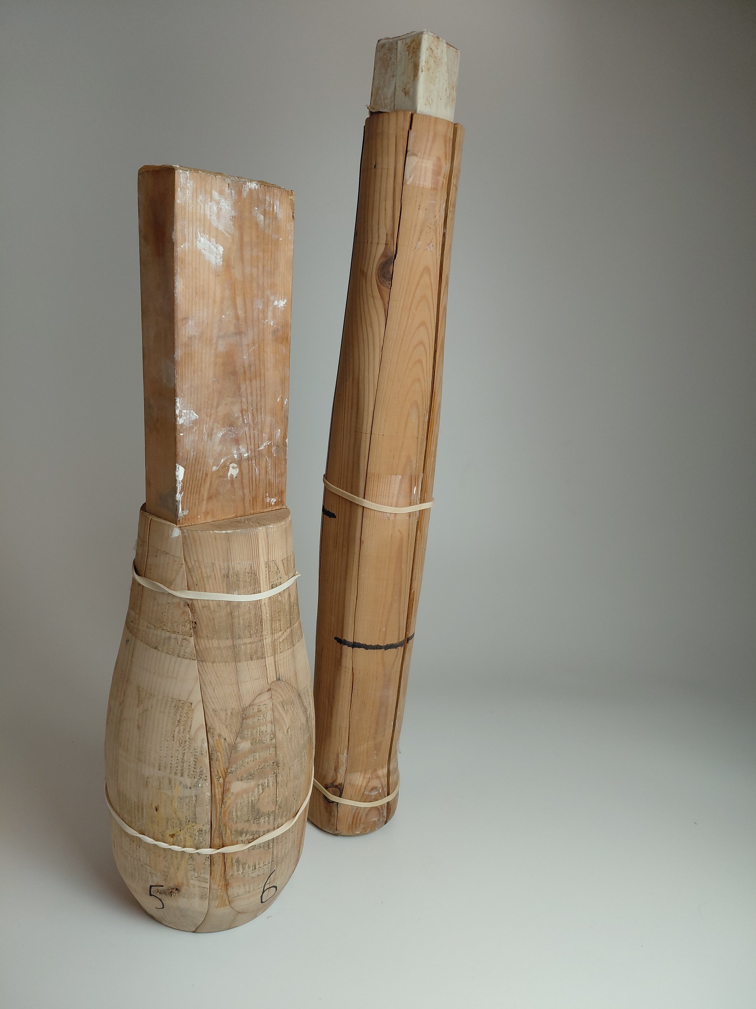 Three cut sections of bamboo, each bound with white rubber bands, numbered 5, 6, and 7, arranged vertically on a plain background.