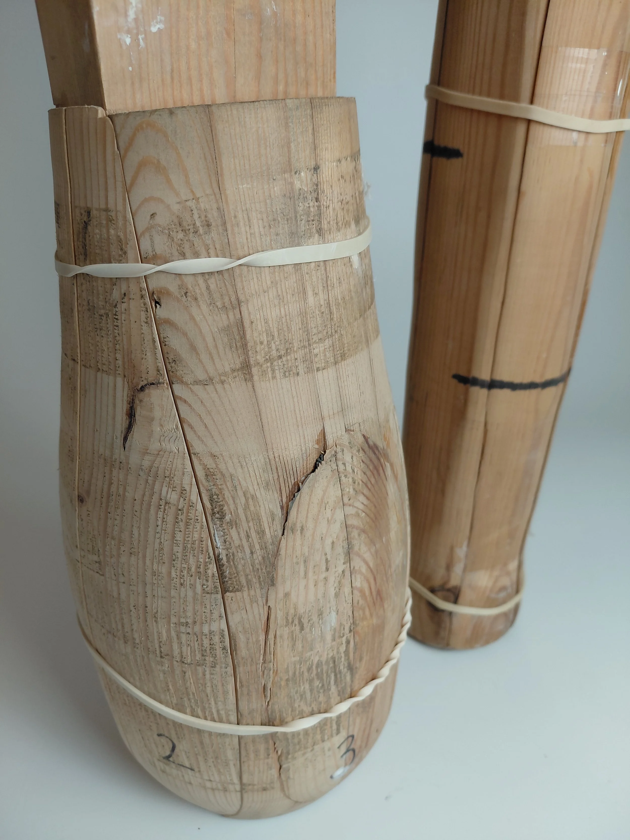 Turned wood formers, showing numbered parts extracted from soft slab construction after drying.
