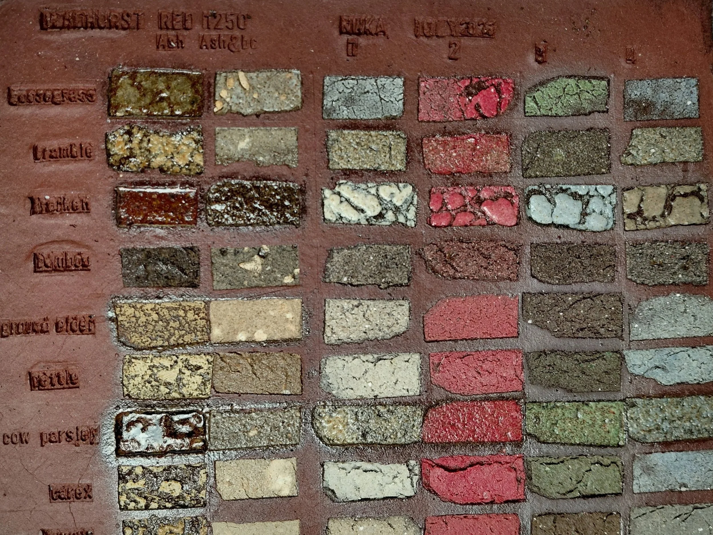 A color chart showing various brick samples arranged in rows with label references, some bricks are worn, stained, or painted.