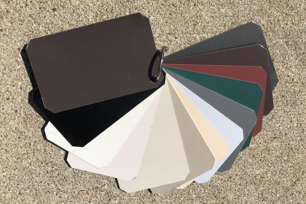 A color palette with multiple swatches fanned out on concrete ground.