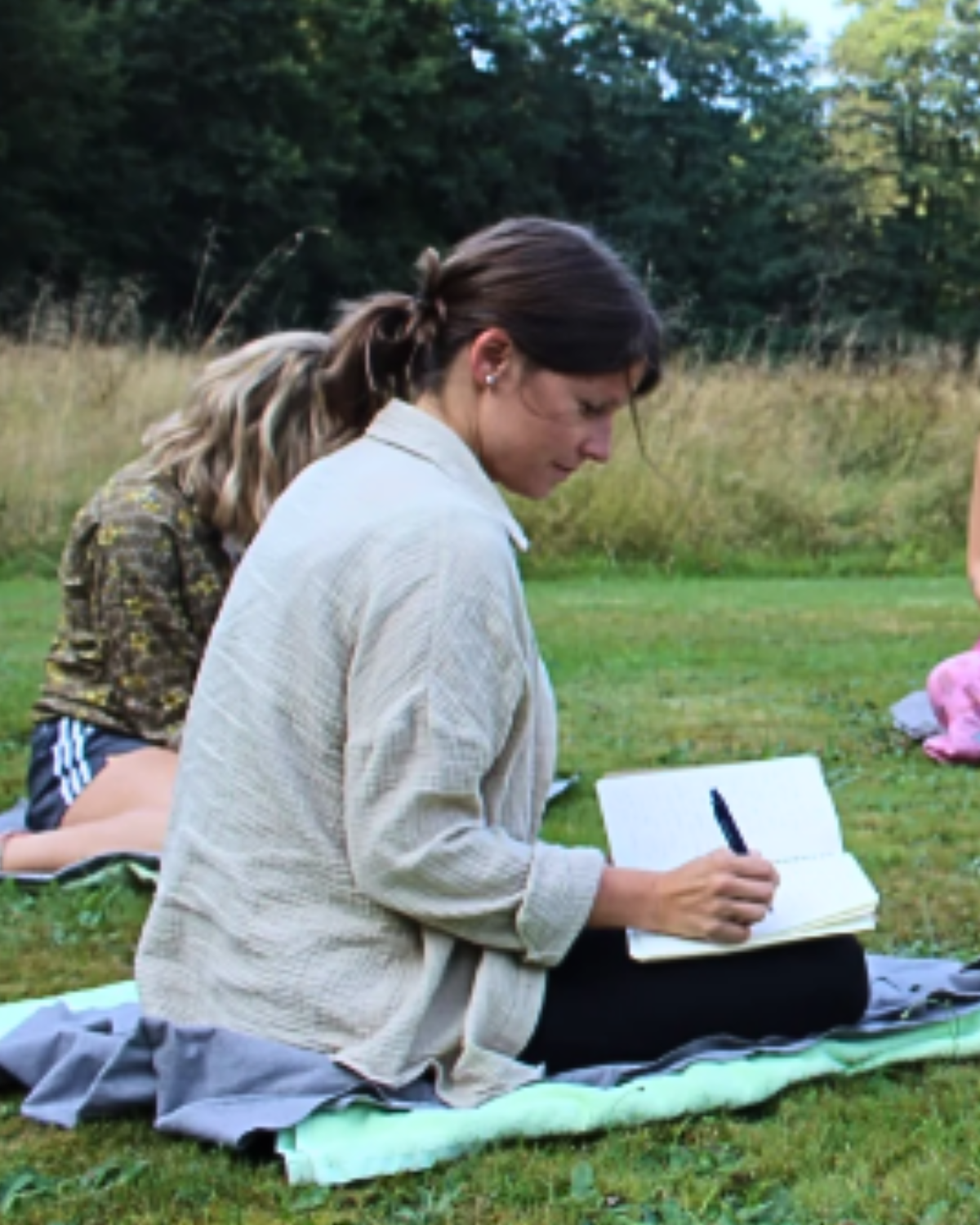 Participant in a Leah Ann Hill retreat experience engaging in guided journaling and reflection for connection and restoration.