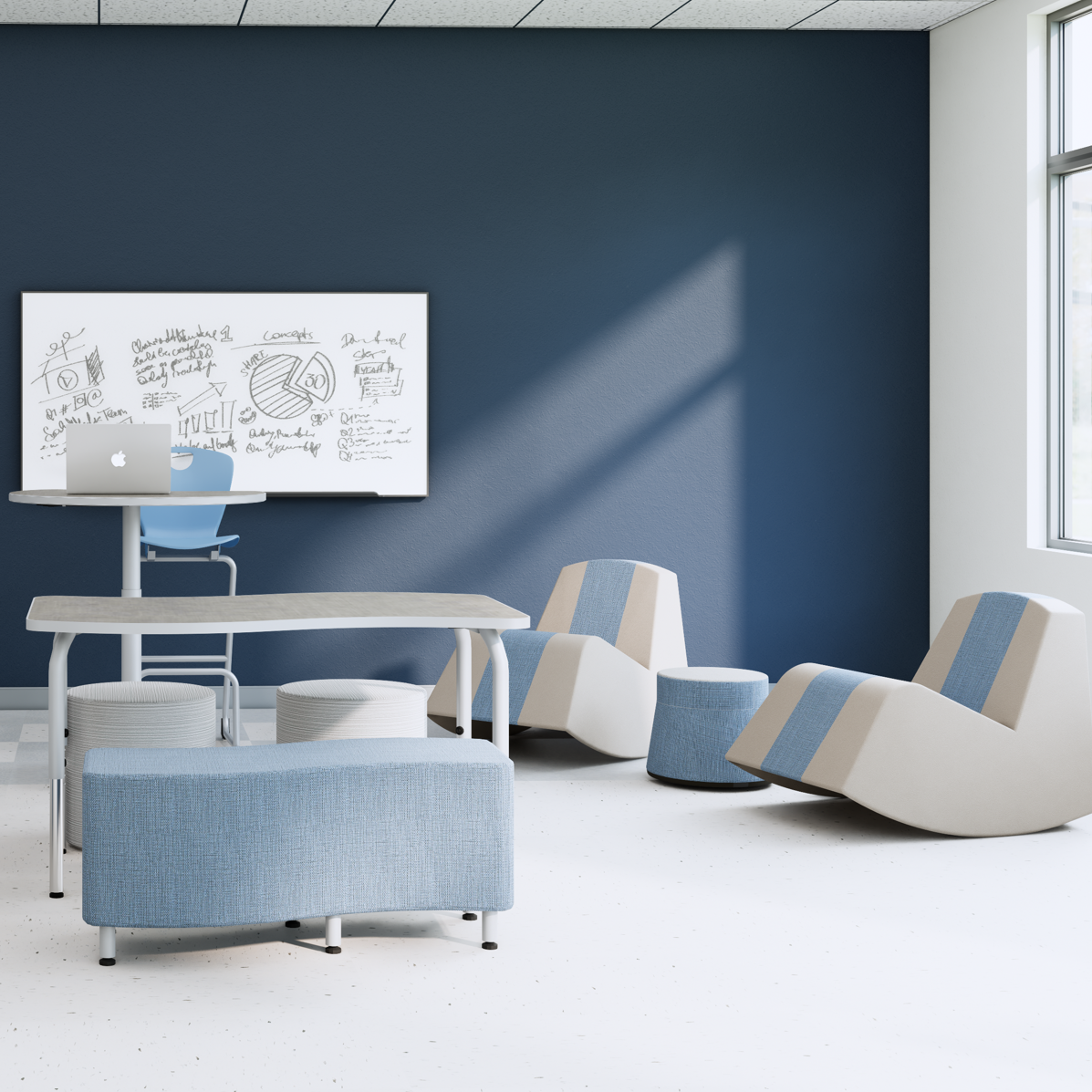 Modern office or lounge with blue and beige furniture, a whiteboard with sketches, a laptop on a high table, and large window letting in natural light.