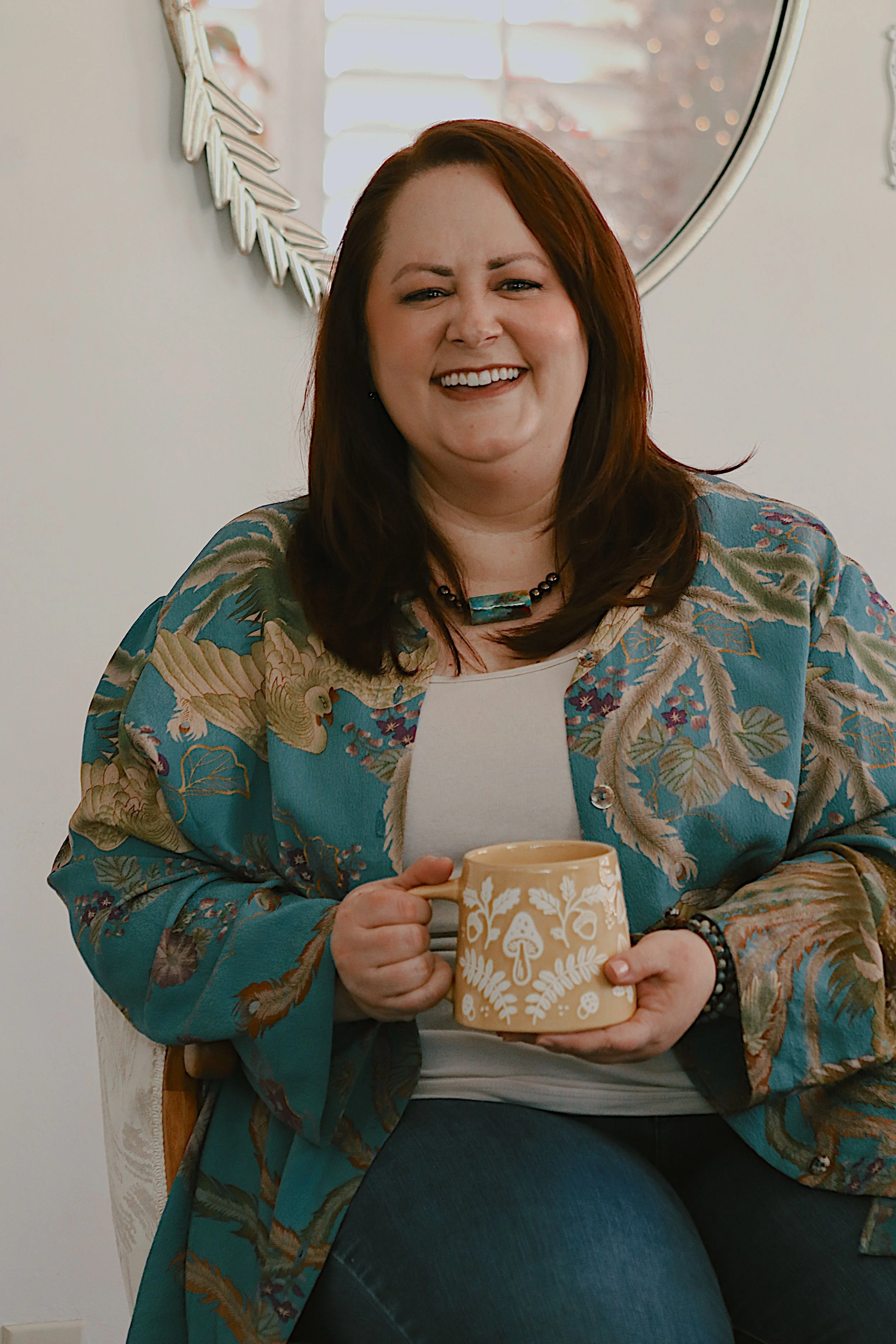 Sarah Pate, early childhood education consultant and founder of The People Grower, smiling while holding a mug and welcoming parents, educators, and preschool leaders to connect.