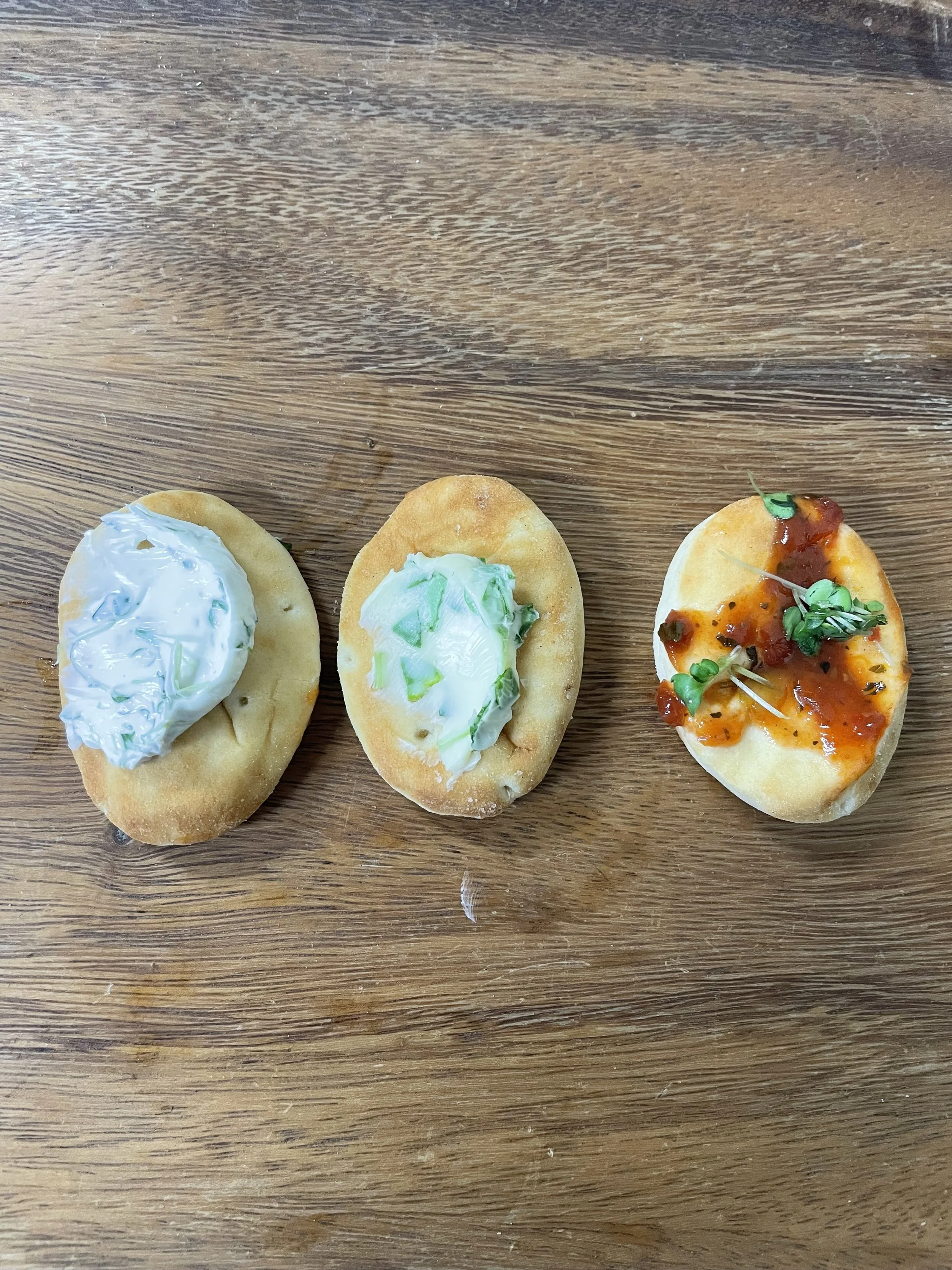 Microgreens Compound Butter, Cream Cheese, and Tomato Sauce on Naan ( at Nana Kate's))