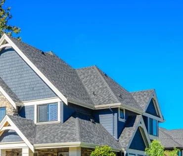 Roof of a modern house against a clear blue sky