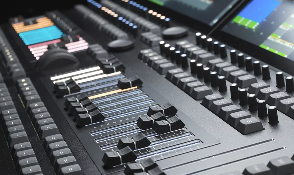 Close-up of a professional audio mixing console with various sliders, knobs, and a digital display