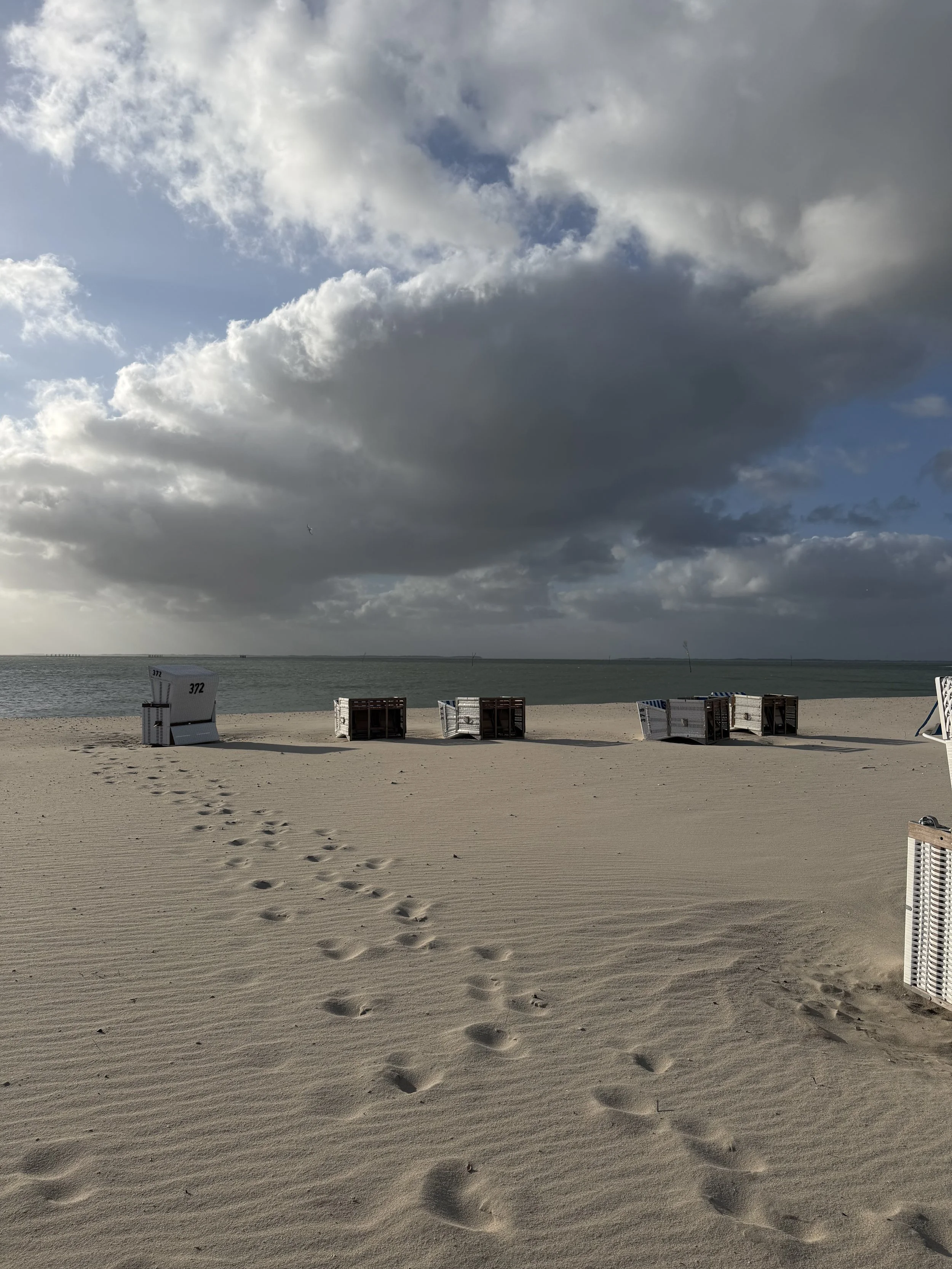 Morning after night of big storm. Strandkoerbe toppled over. Sand brushed clean