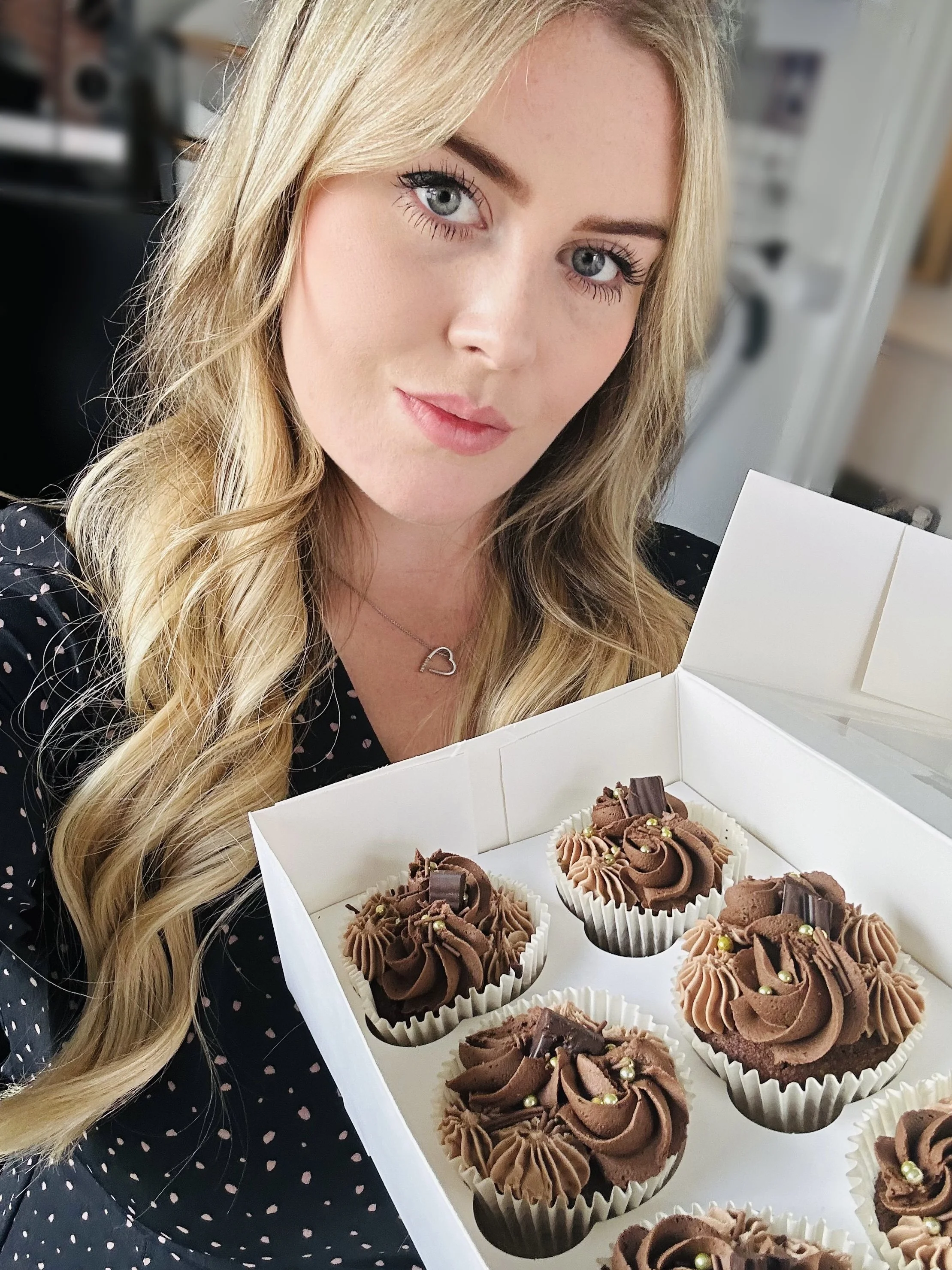 Isabelle Golder holding a box of chocolate cupcakes, Woodbridge, Suffolk