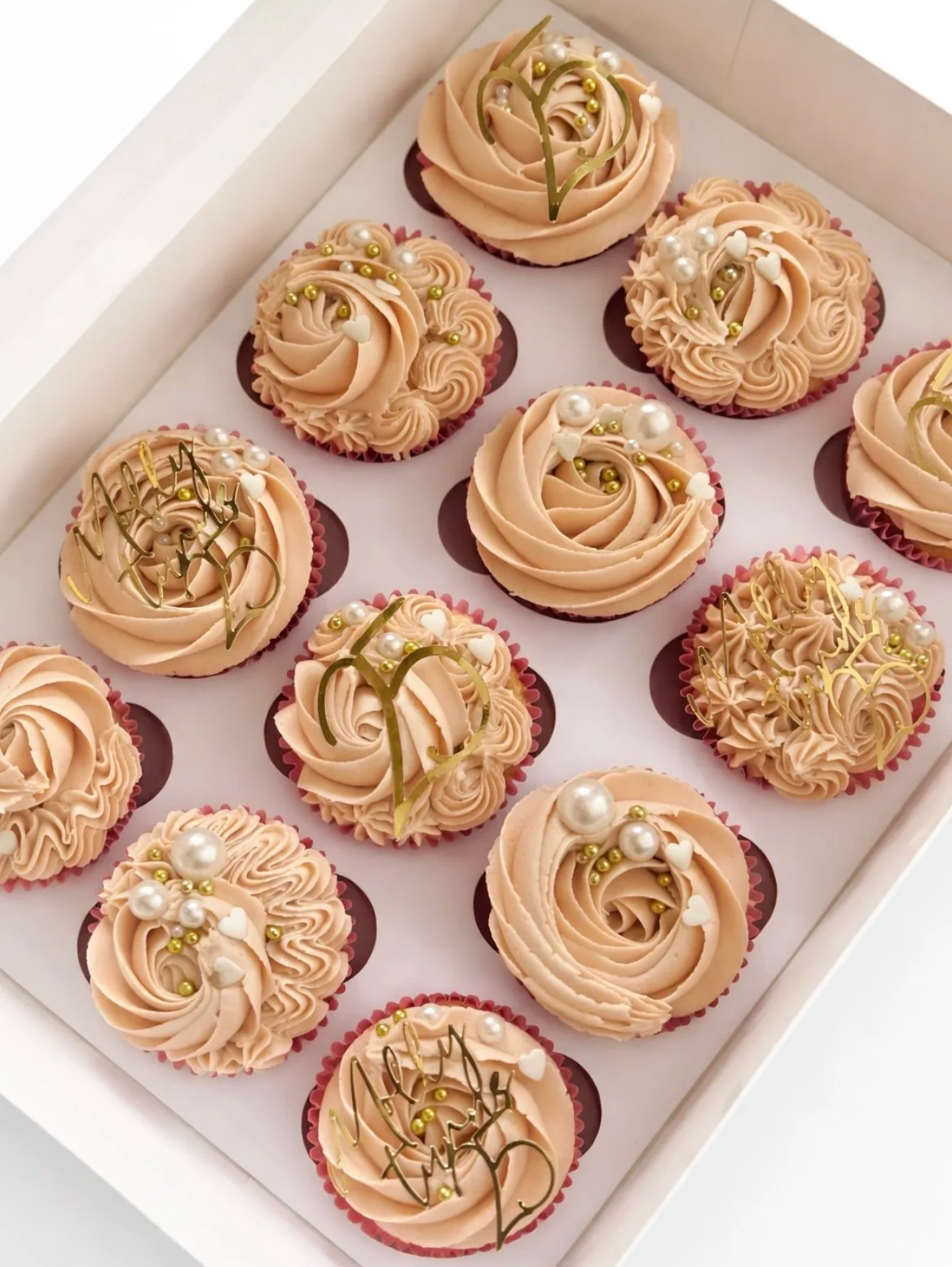 Box of buttercream cupcakes with pearl and gold decorations, Woodbridge, Suffolk