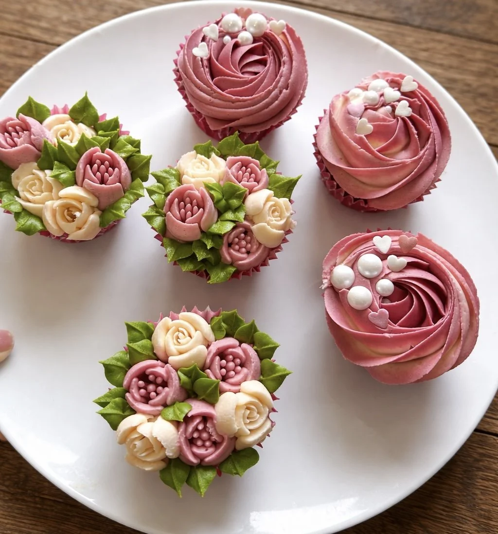 Pink buttercream cupcakes with piped flowers and pearls