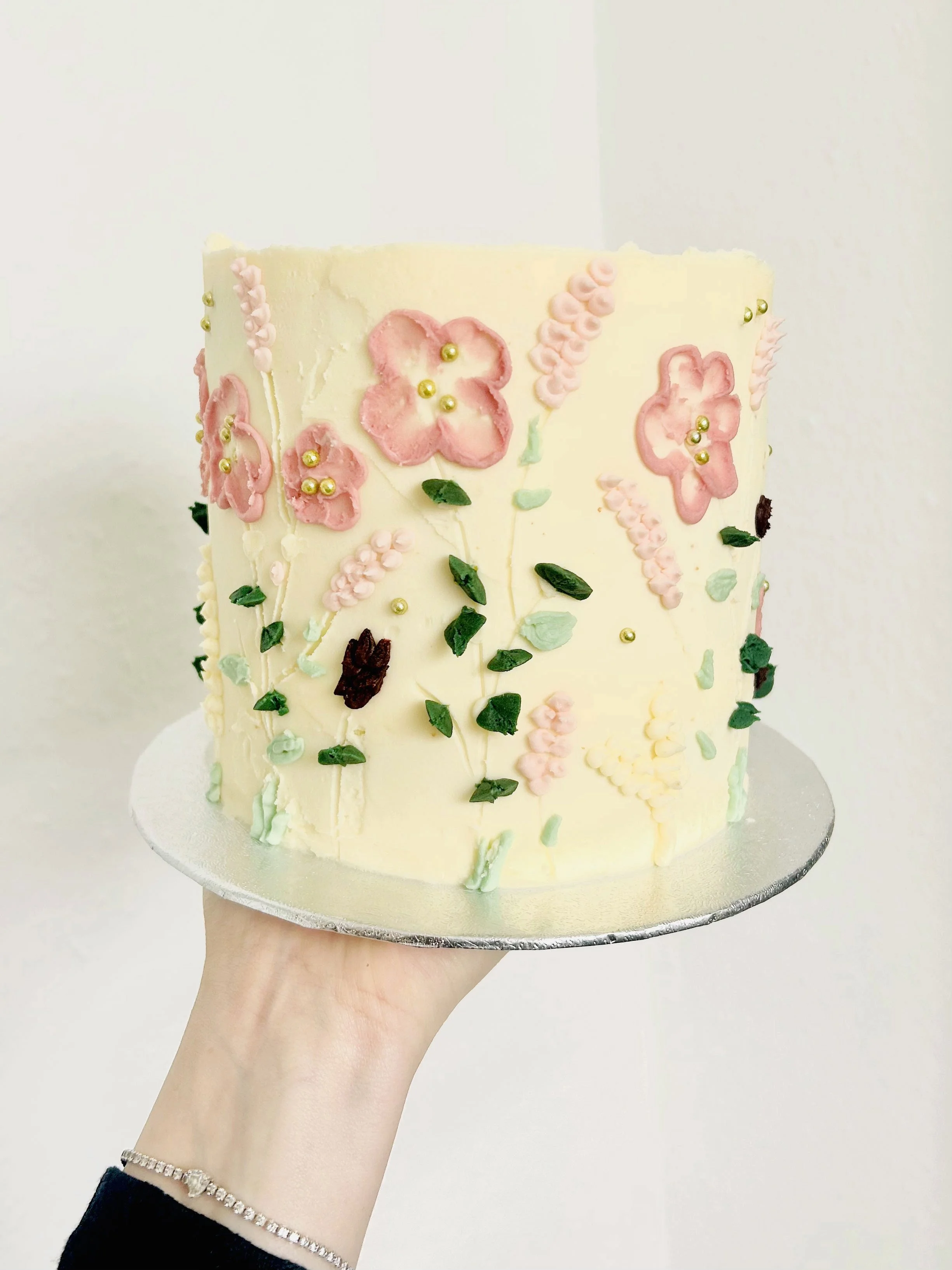 Buttercream cake with hand-piped flowers