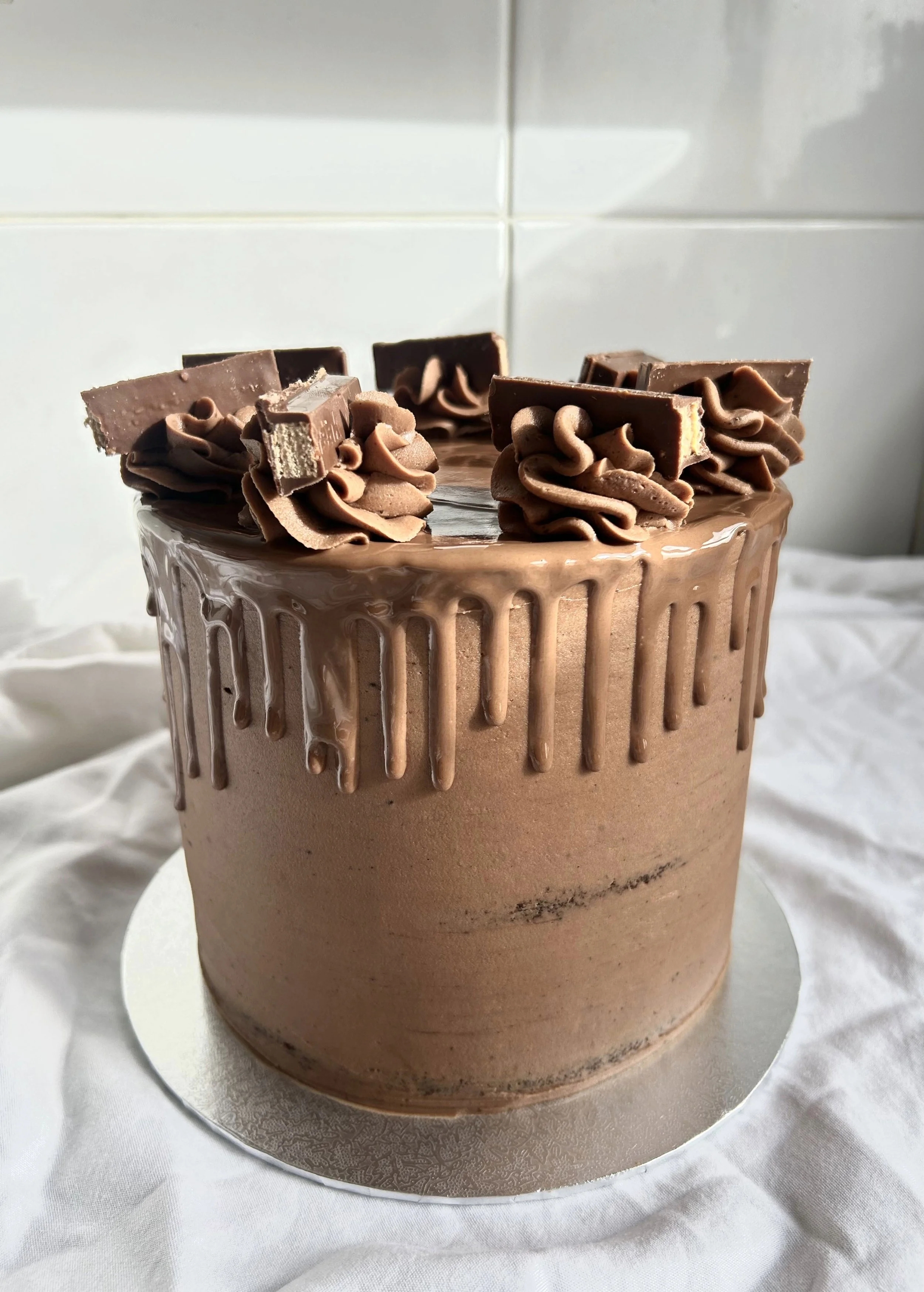 Chocolate drip cake with chocolate buttercream and chocolate pieces