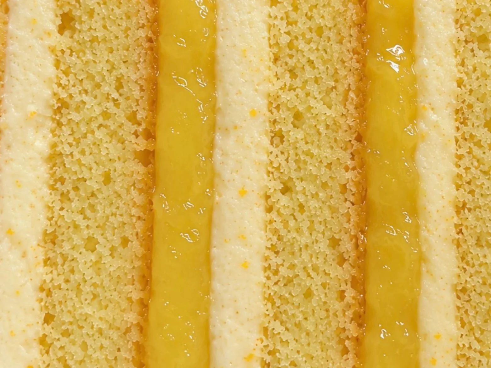 Cross-section of lemon sponge layered with lemon curd and lemon buttercream