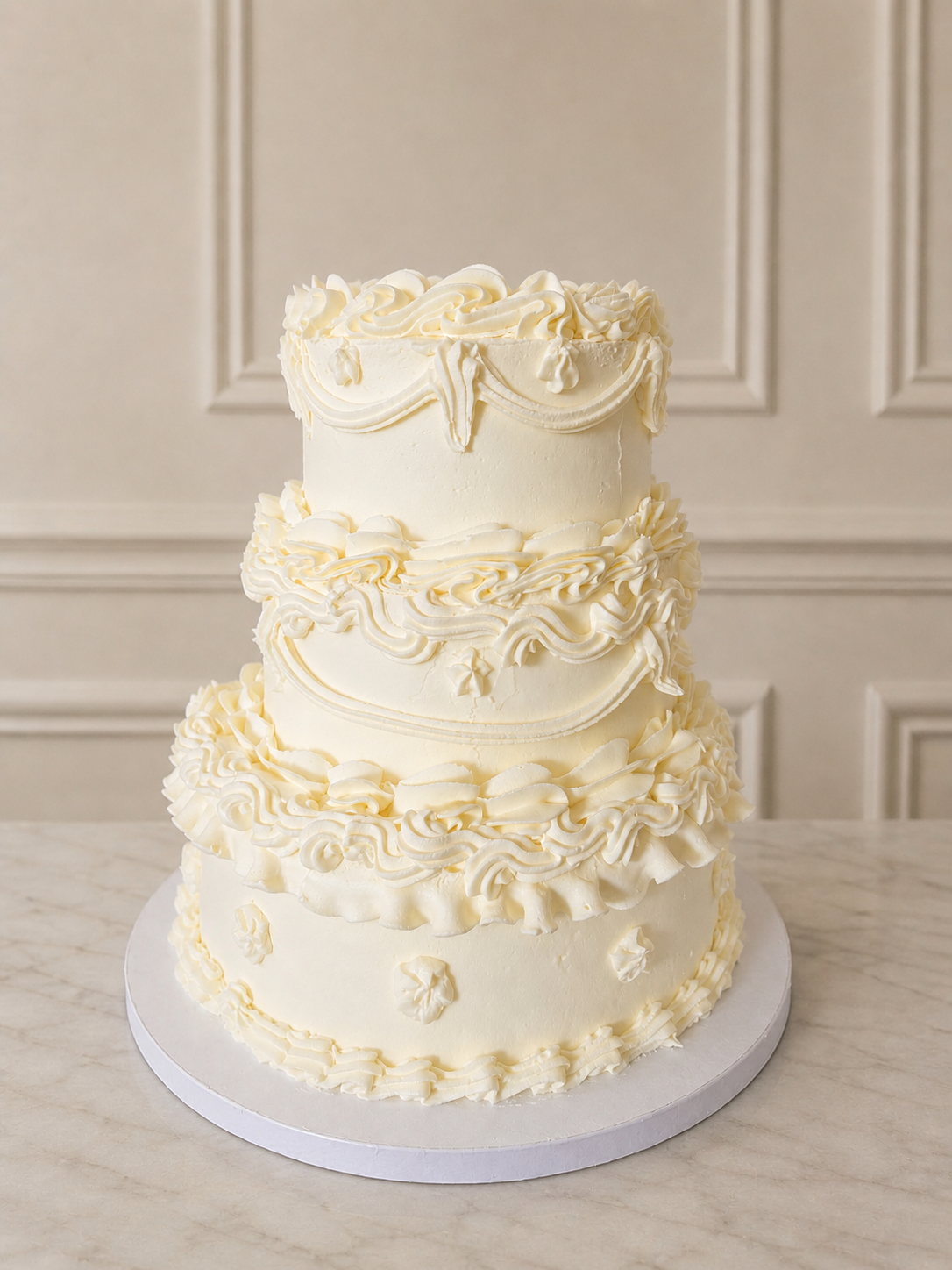 Three-tier white Lambeth wedding cake