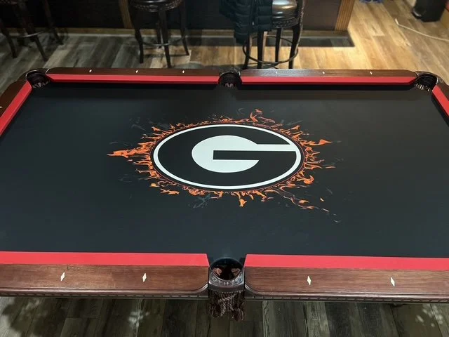 Outdoor hockey table featuring a G logo surrounded by an orange splash design.