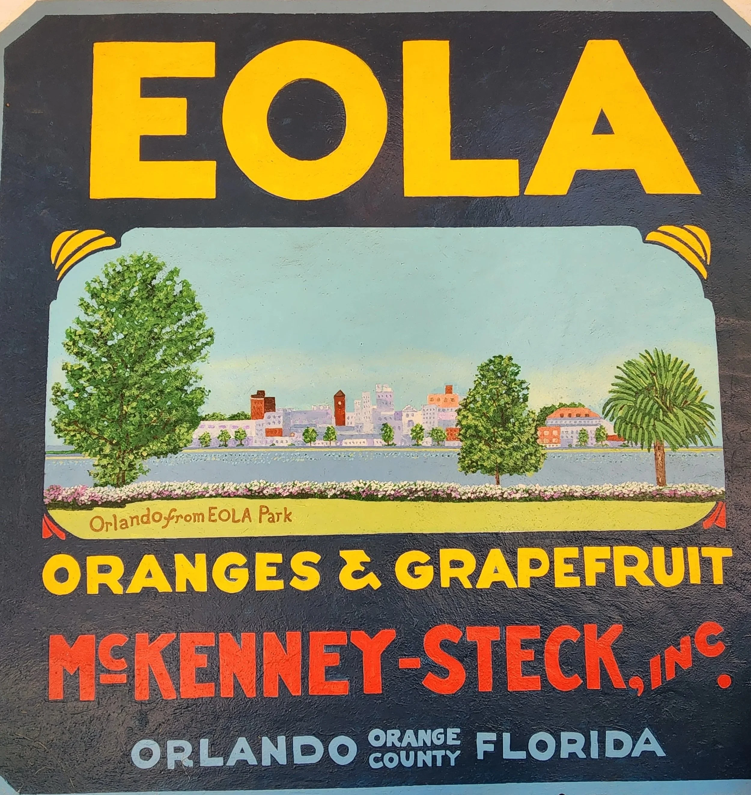Vintage sign promoting oranges and grapefruit from EOLA Park in Orlando, Florida, with an illustration of the park's landscape, including trees and a city skyline in the background.