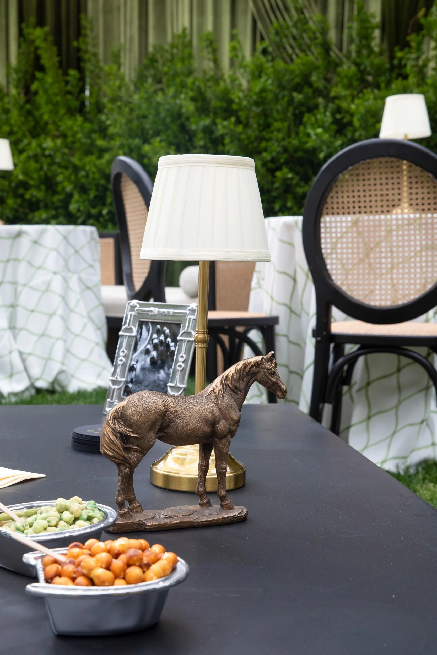 Equestrian-inspired tabletop styling featuring sculptural horse details and layered textures throughout the custom Kentucky Derby celebration.