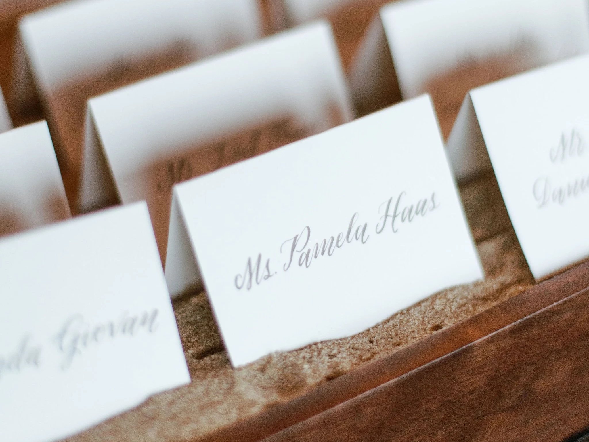 Escort cards were thoughtfully displayed in sand gathered from the Montauk shoreline—an understated yet meaningful detail that tied the experience seamlessly back to the ocean.