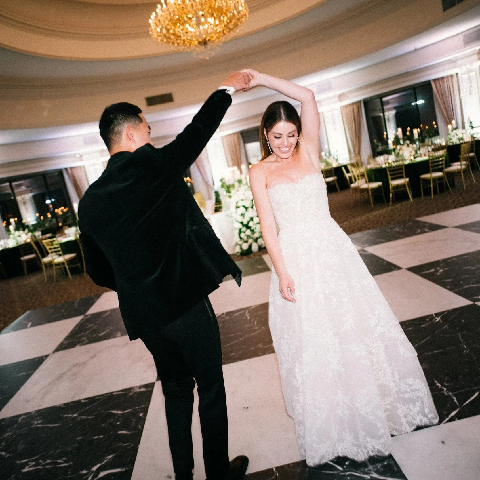Bride and Groom portrait on their black and white checkered dance floor in Oheka Castles ballroom moments before their wedding reception 