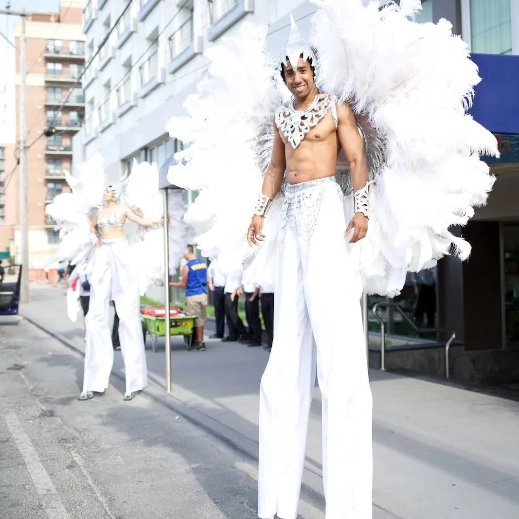 Performers on stilts dressed to greet guests at the entrance of the Allegria Hotel in Long Beach, NY for an event.