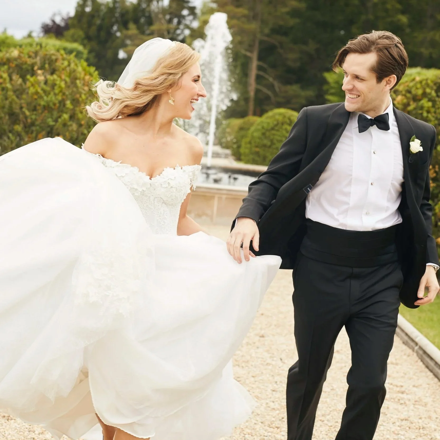 Wedding couple running in the water gardens at Oheka Castle 