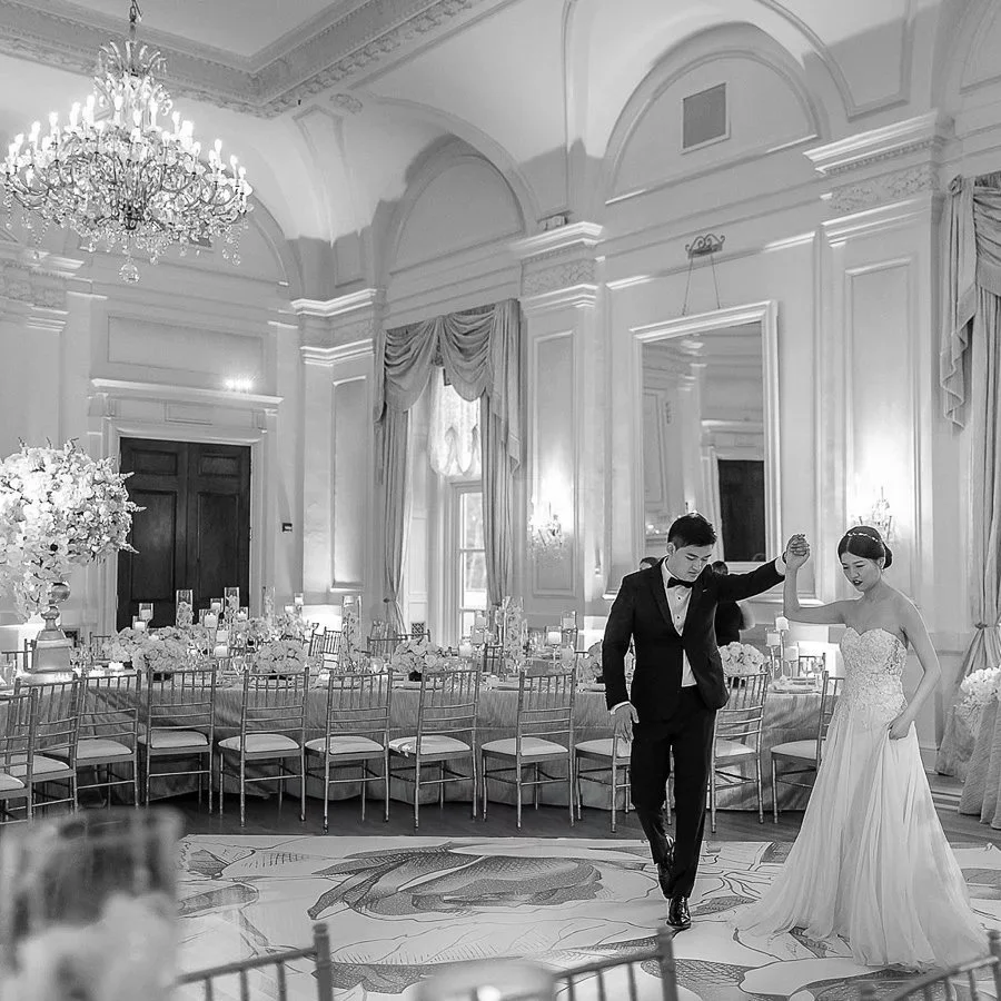 Couple portrait on their custom floral dance-floor in the Grand Ballroom at Oheka Castle 