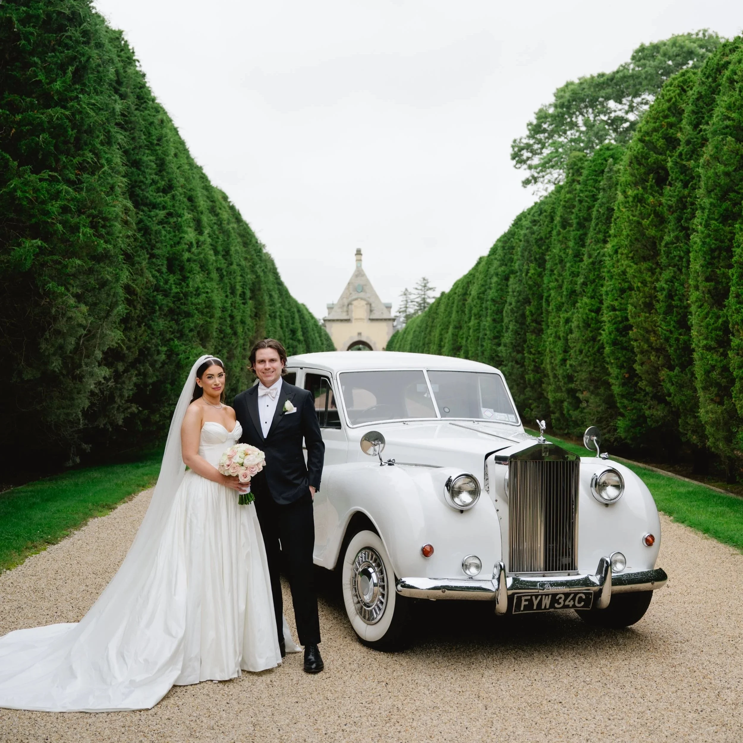 Bride and Groom Portrait with vintage Rolls Royce, in the main driveway of Oheka Castle 