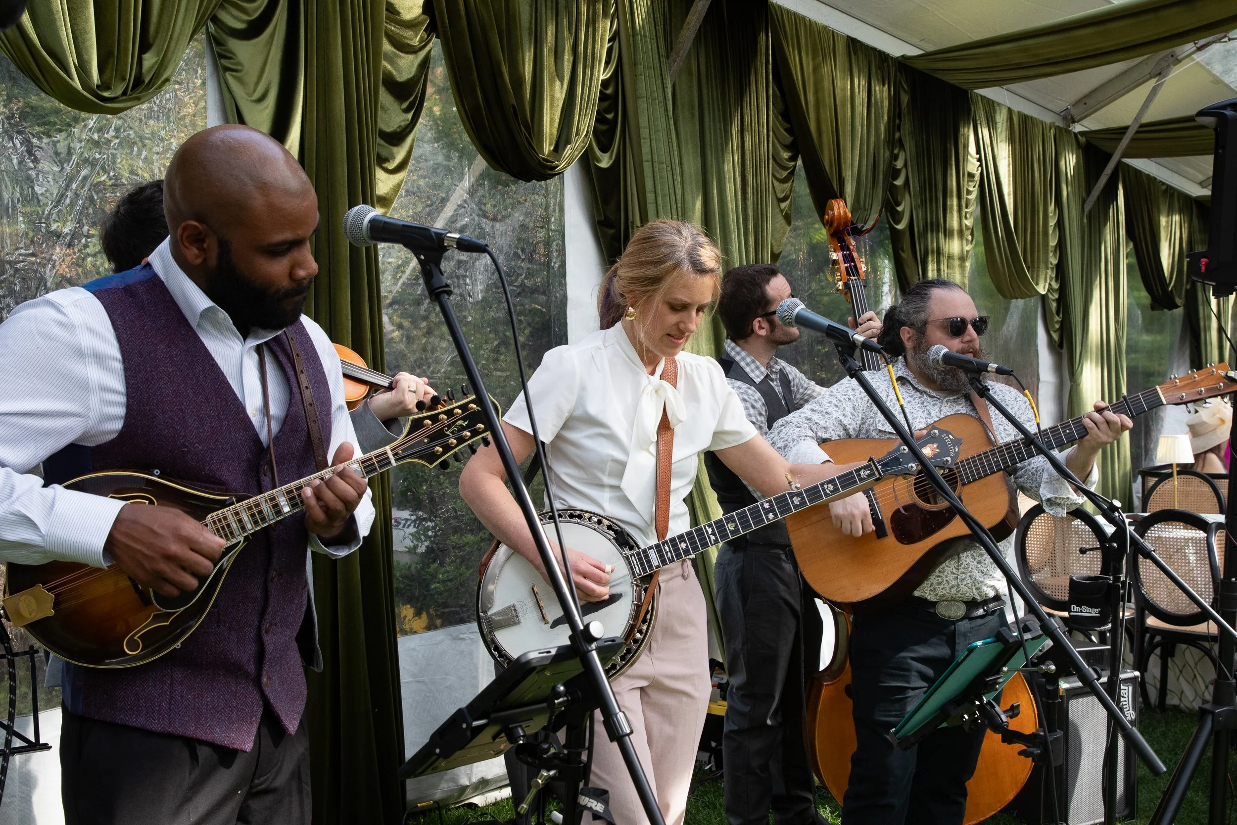 Live bluegrass musicians performing throughout the afternoon, bringing authentic Kentucky Derby energy to the tented celebration.