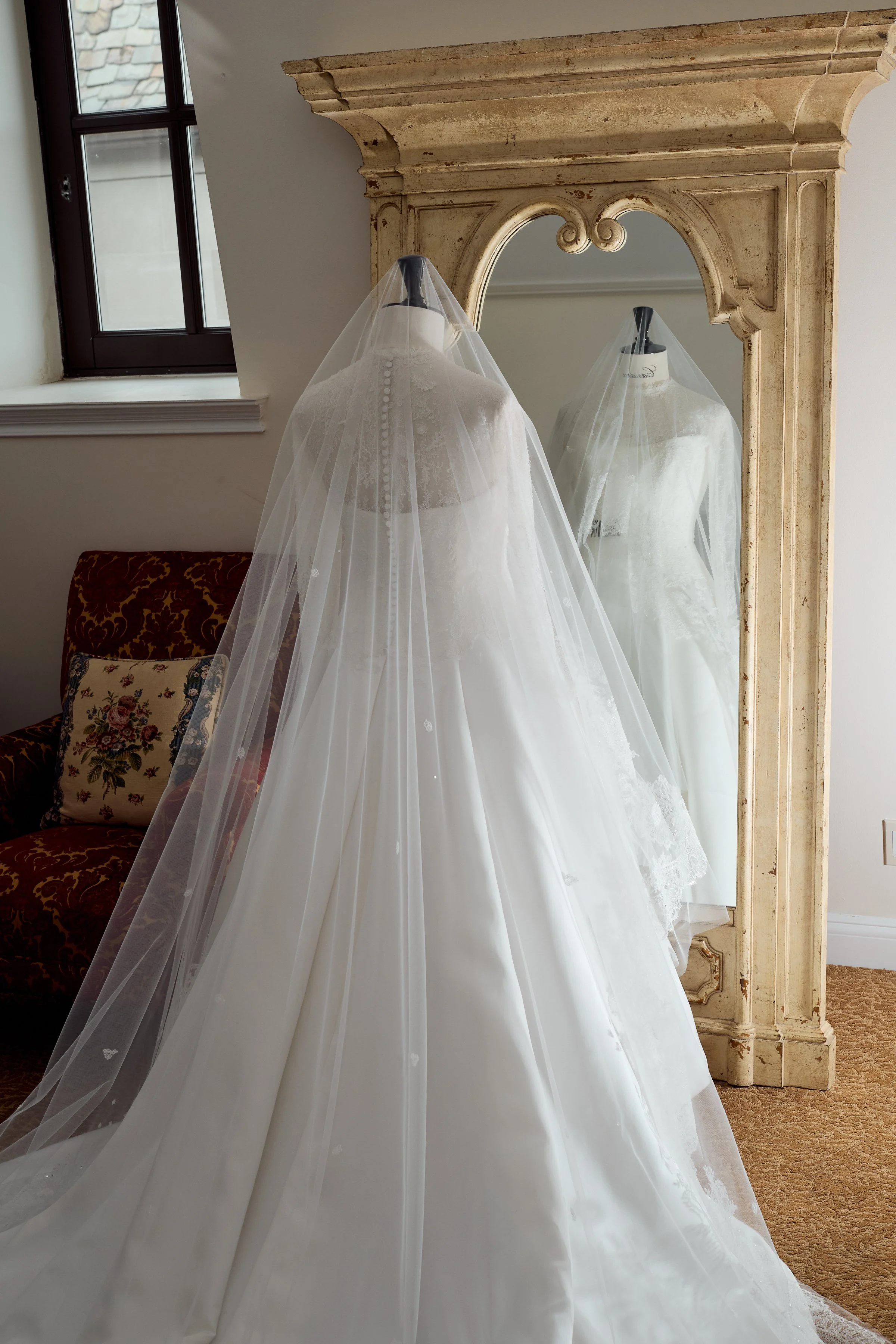 A timeless Christian Dior gown displayed in soft natural light, setting the tone for an elegant and refined celebration.