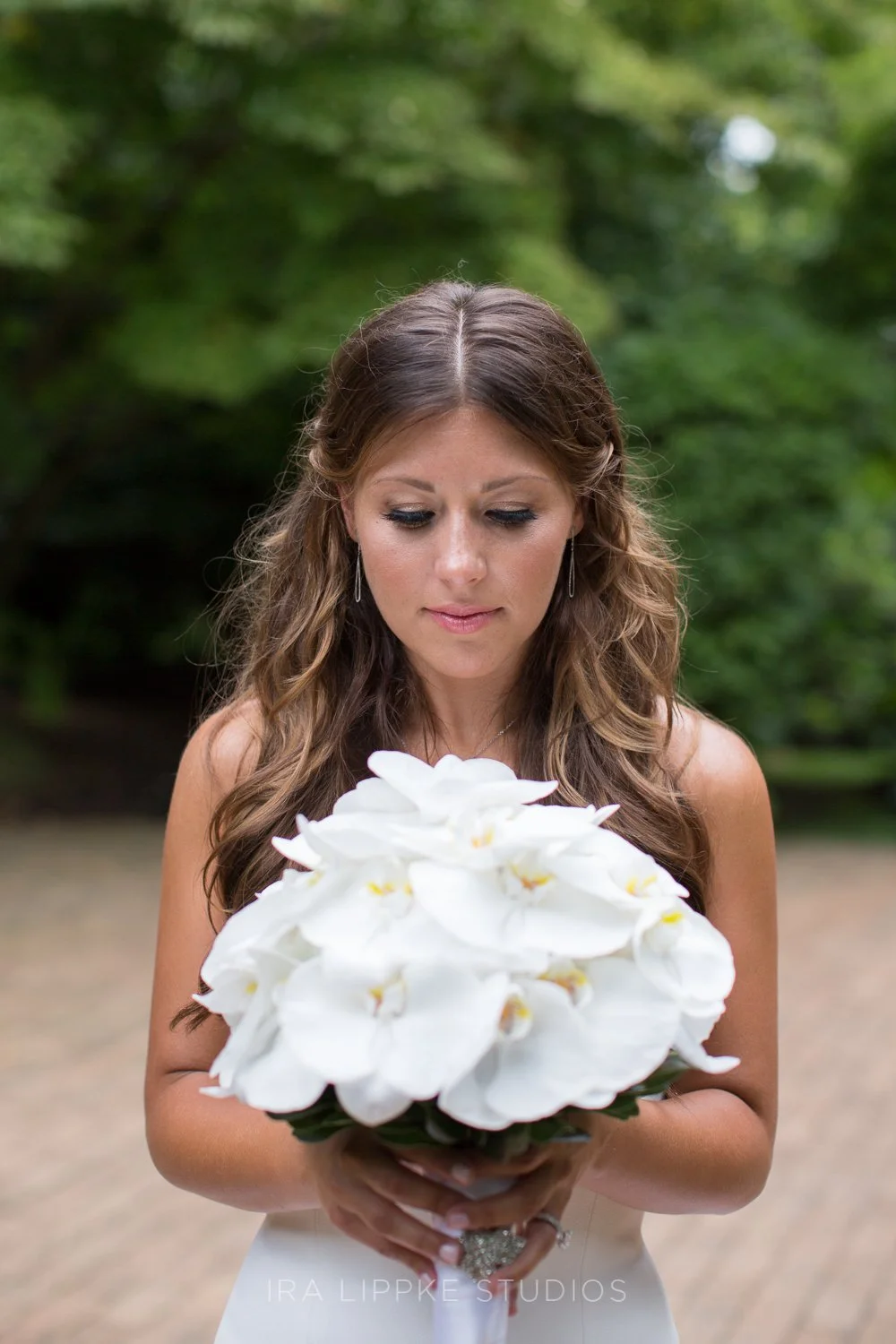 A quiet and elegant portrait of the bride holding her bouquet, capturing a moment of reflection before the ceremony begins.