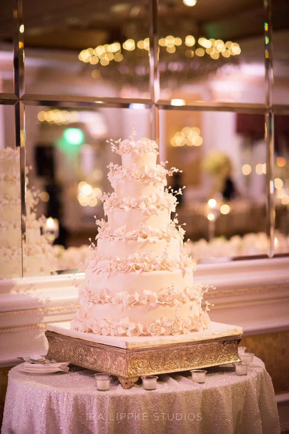 The couple’s elegant wedding cake serves as both a stunning design element and a sweet centerpiece of the celebration.