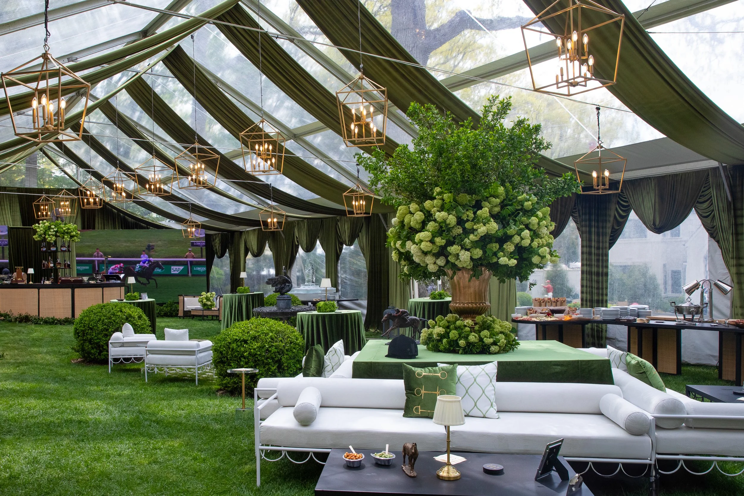Wide view of the immersive tented environment designed from the ground up with layered lounges, custom bars, and dramatic draped ceilings.