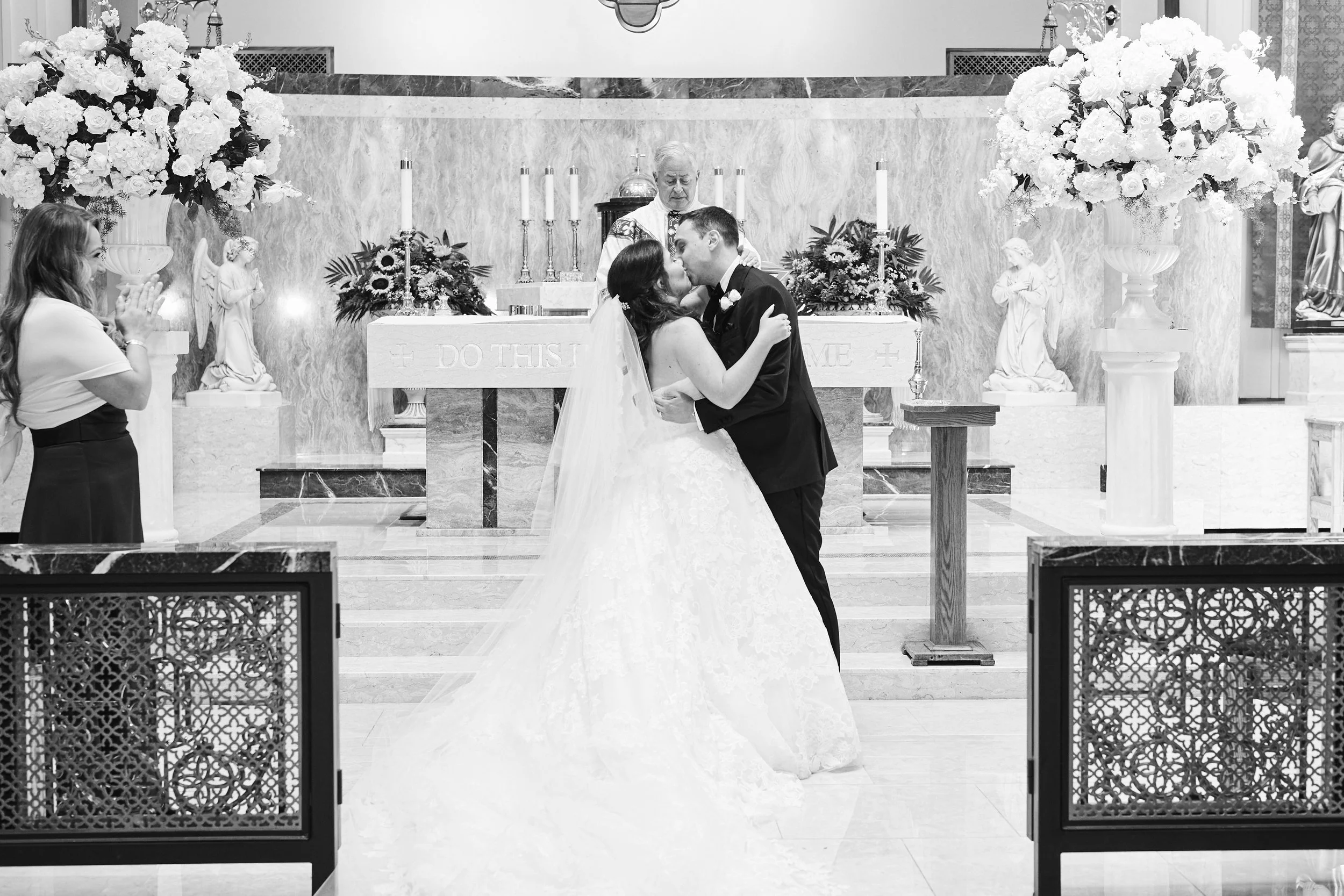 Samantha and Anthony sharing their first kiss as newlyweds inside the church following the wedding ceremony.