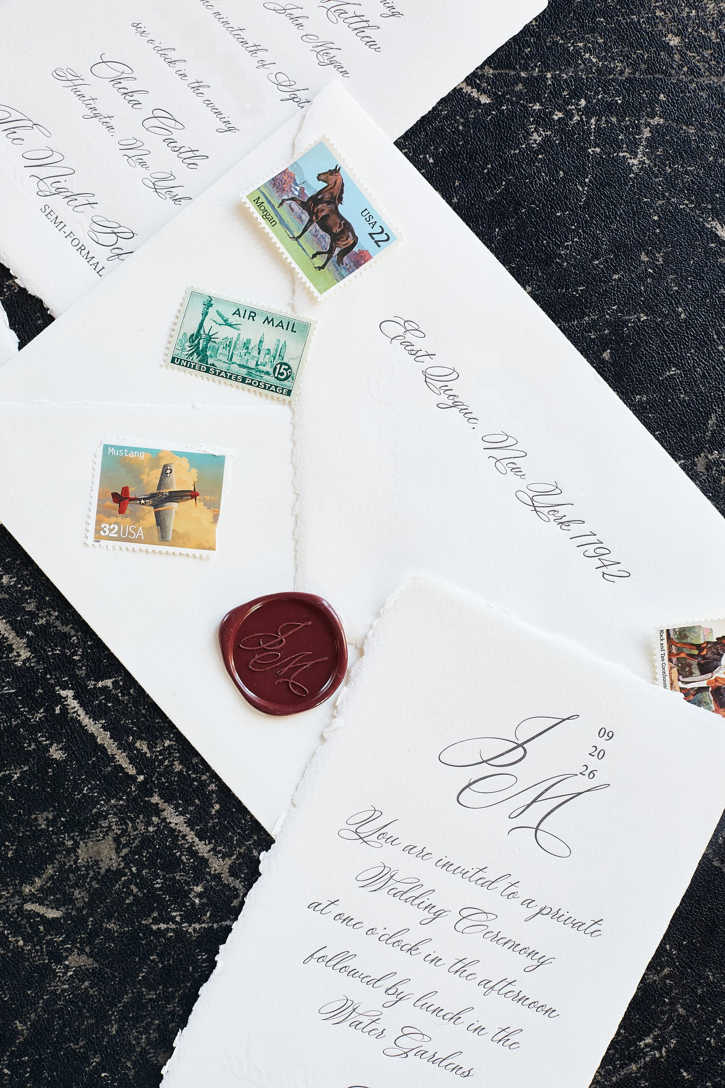 Deckled edge paper invitation suite with vintage postage and waxed seal