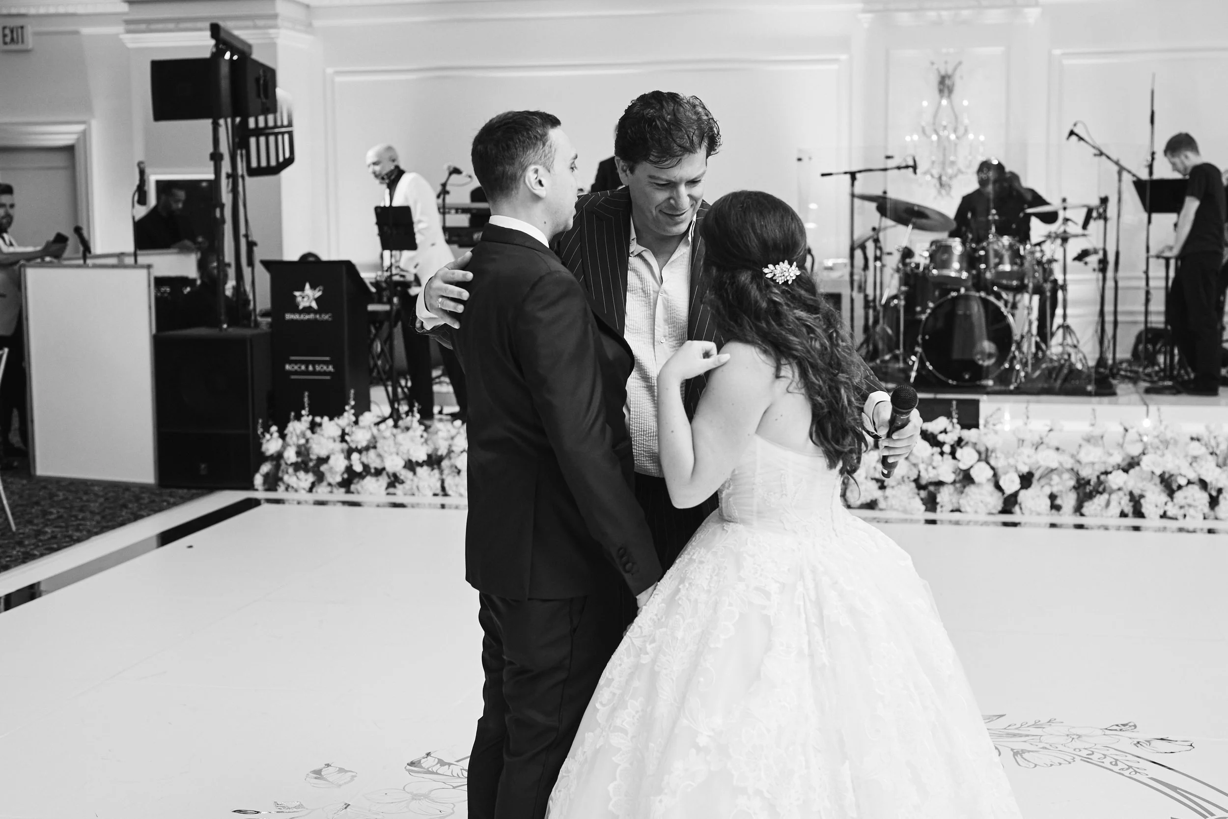 Patrizio Buanne sharing a moment with Samantha and Anthony on the dance floor during the wedding reception celebration at Oheka Castle.