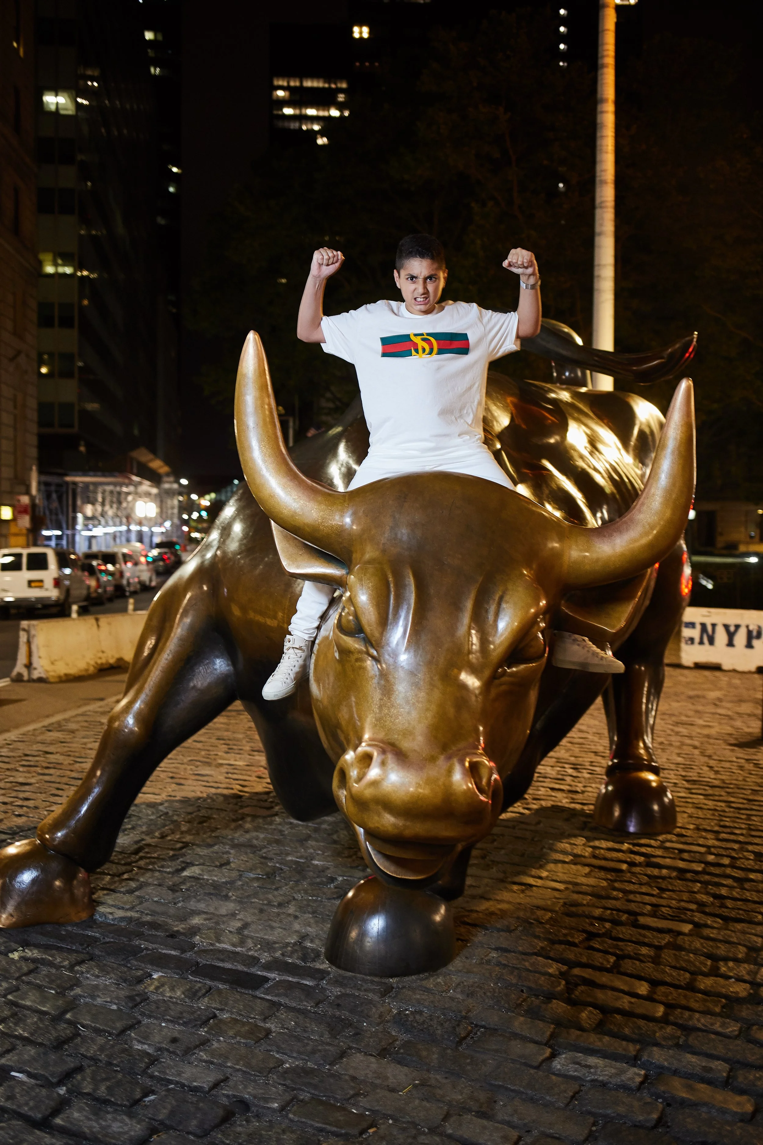 Skyler at the Charging Bull on Wall Street in New York City — a bold, playful portrait capturing his personality against one of the city’s most iconic landmarks.