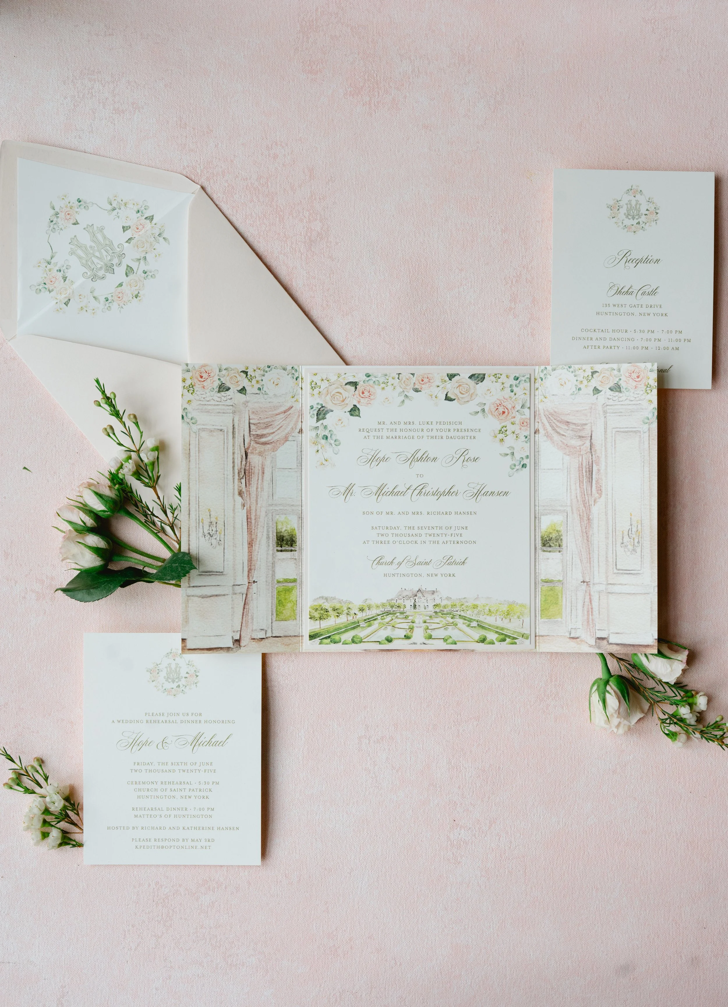 Wedding invitation set on pink textured background, including a main invitation, reception card, and RSVP card, adorned with floral accents and greenery.