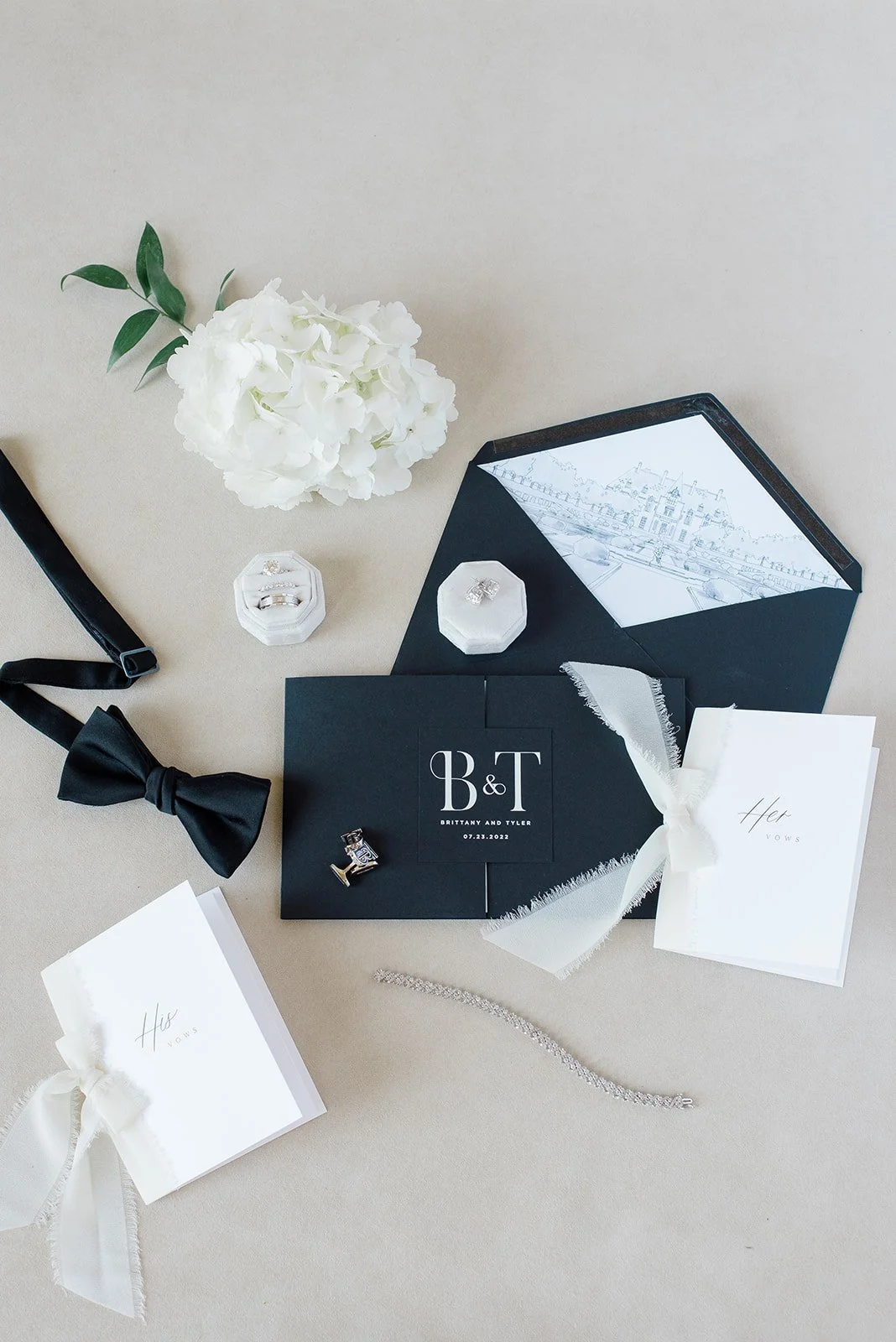 Black gate fold wedding invitation suite with modern white monogram closure