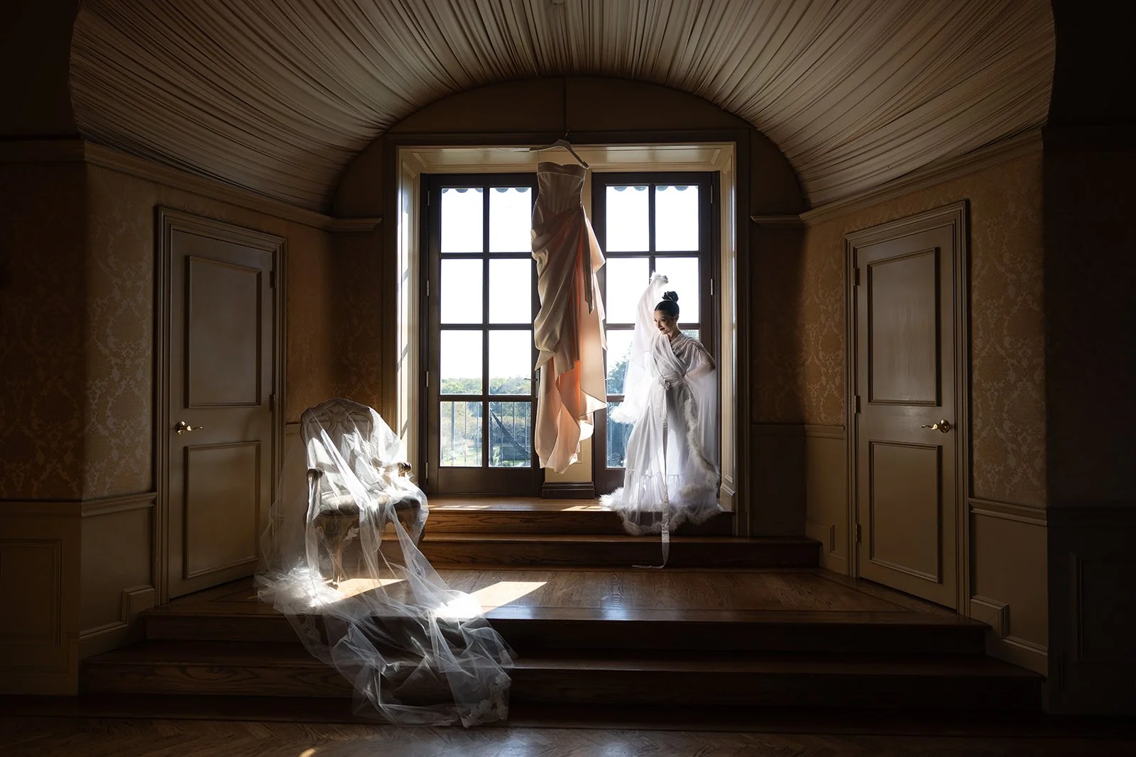 Anna Louise and Michael’s moody fall wedding at Oheka Castle featured burgundy and moss green tones, sculptural florals, candlelit tablescapes, and vintage French–inspired stationery.