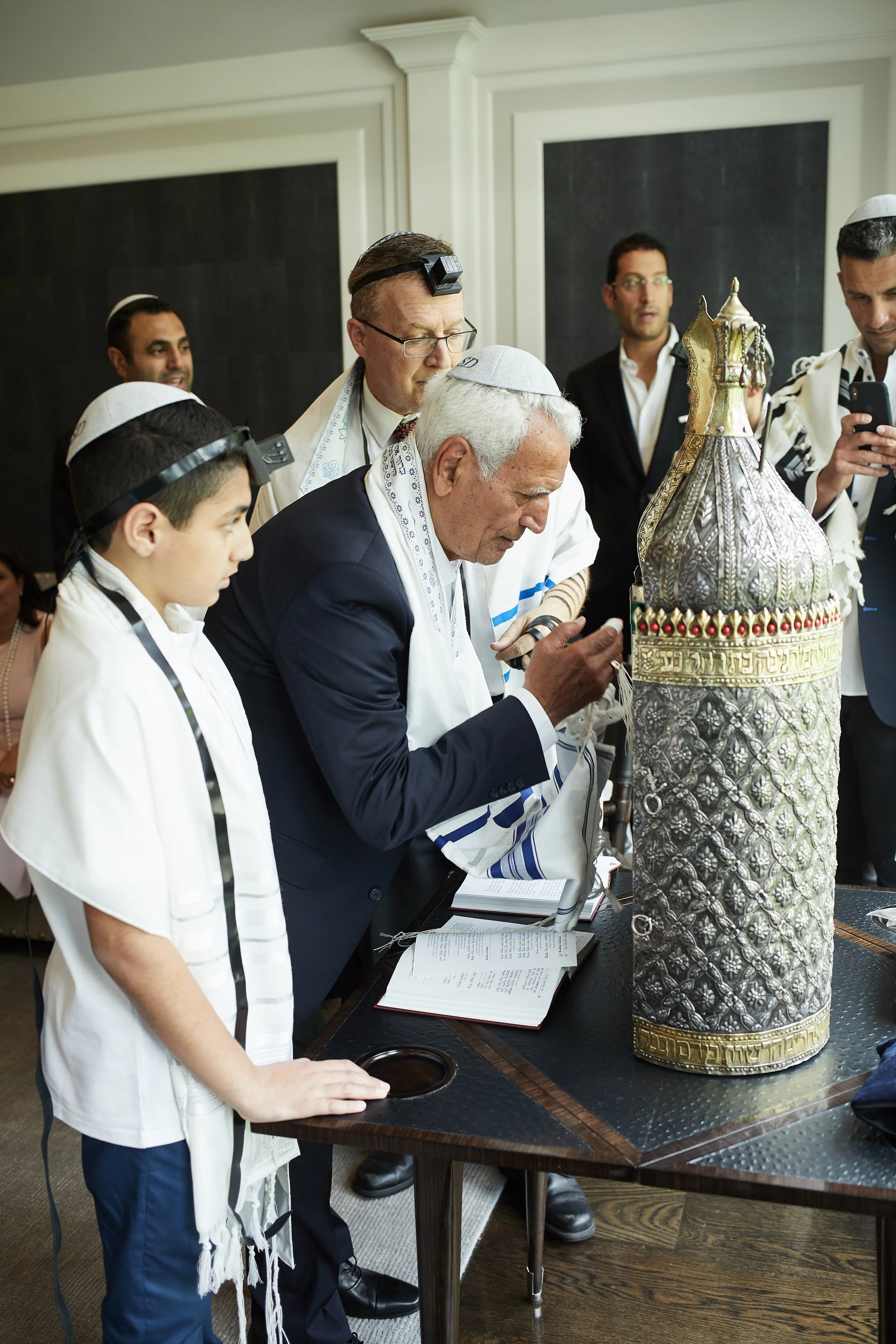 Torah reading during Skyler’s Bar Mitzvah at Cipriani Wall Street in New York City — a meaningful moment of tradition as generations gather closely, honoring heritage with quiet reverence and intention.