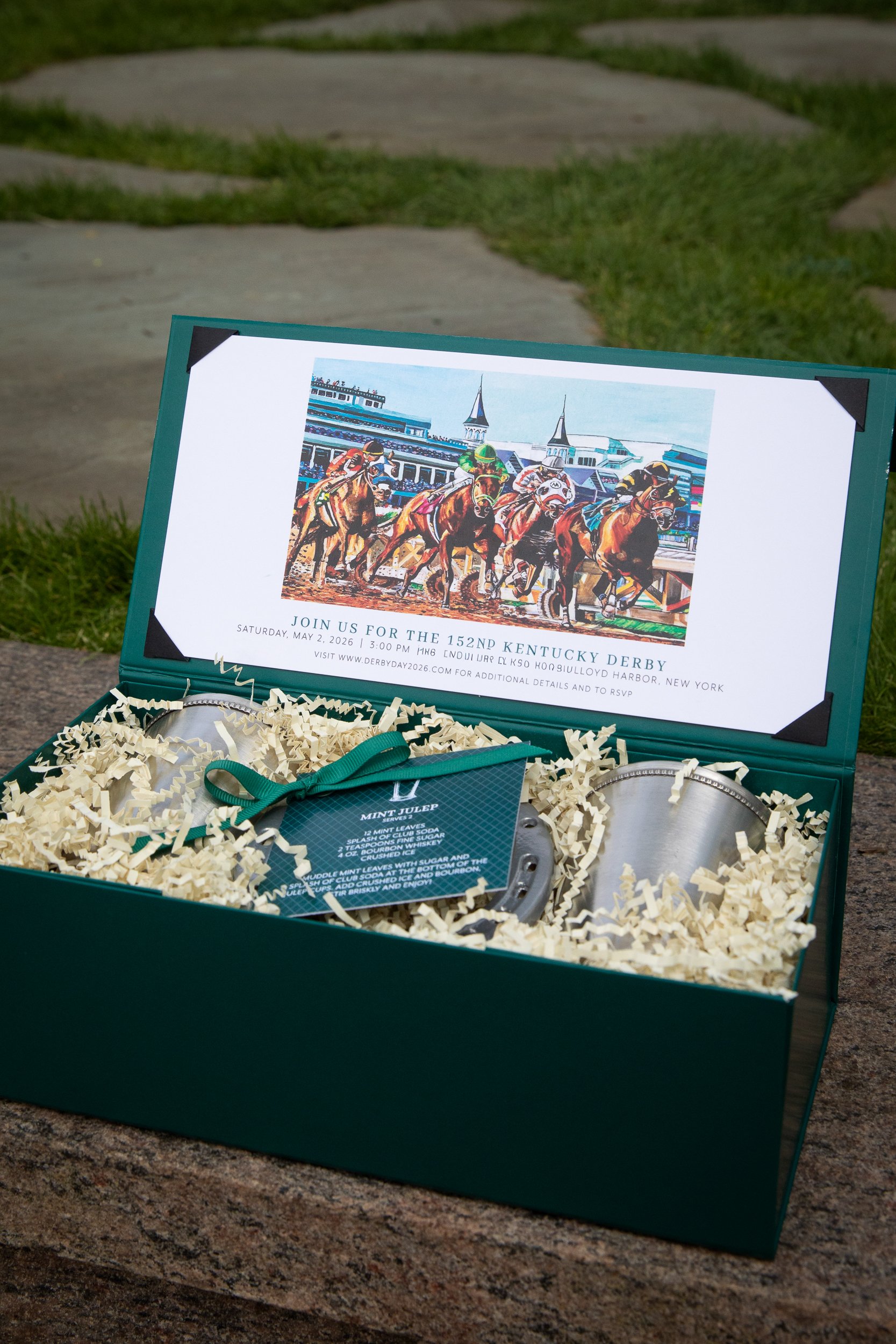 Bespoke invitation presentation featuring engraved julep cups, horseshoes, custom Derby artwork, and handcrafted mint julep recipes.