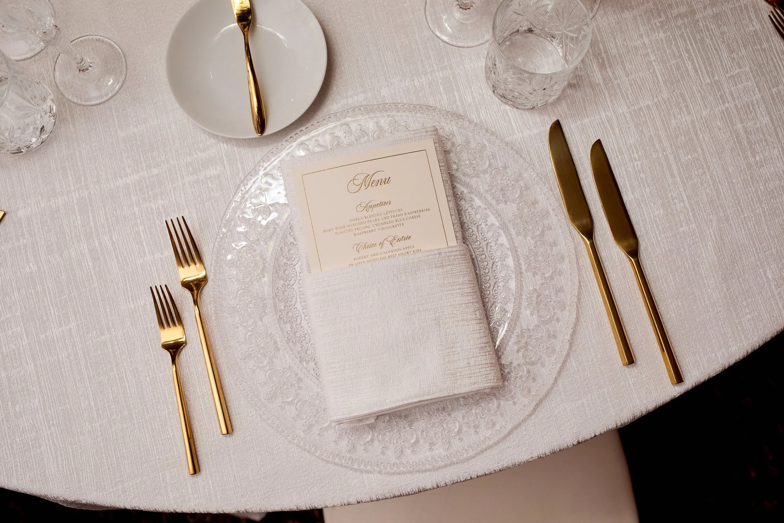 A minimalist place setting layered with texture, tone, and subtle detail.