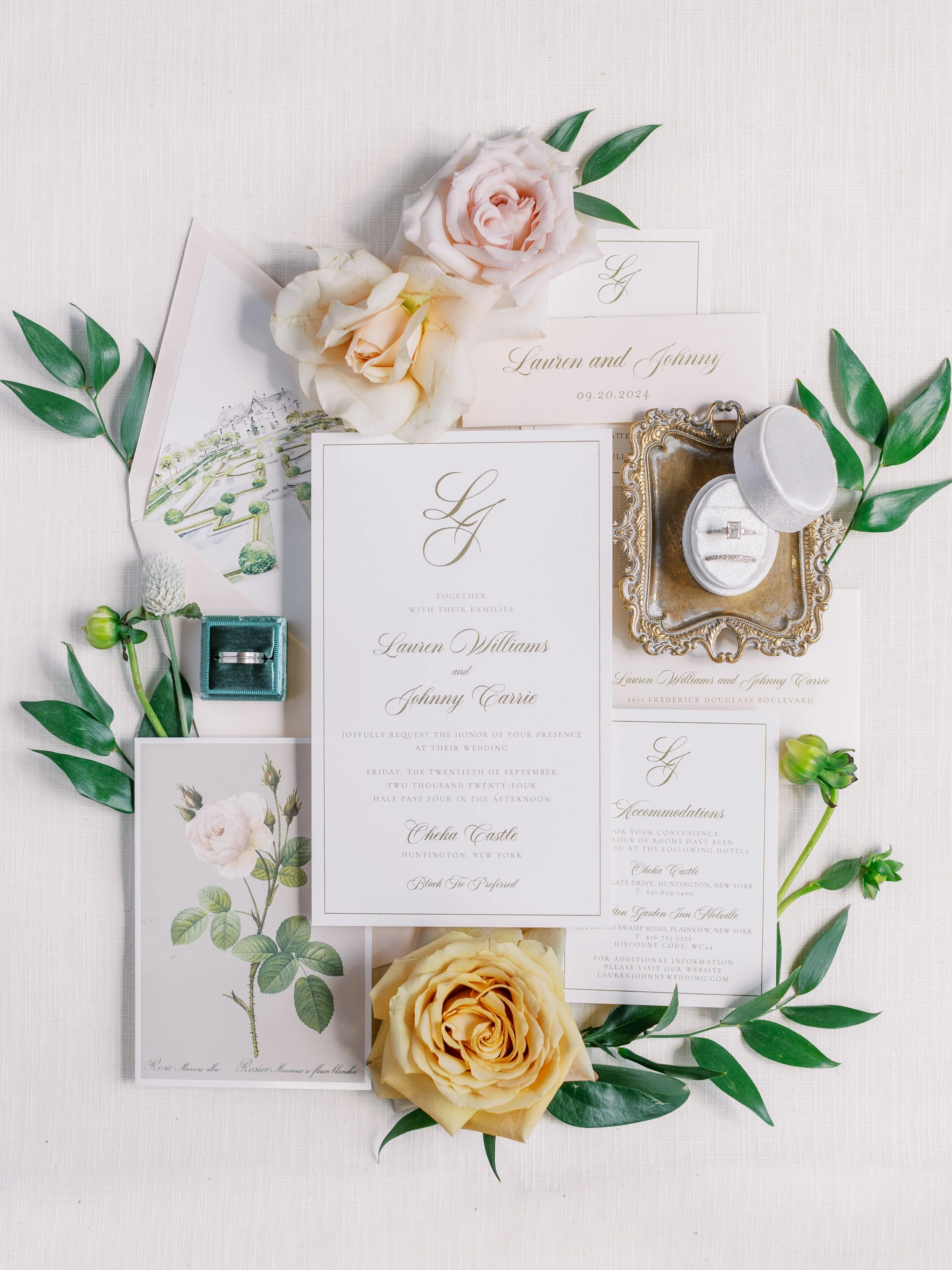 Wedding invitation suite with blush pink envelope and bellyband, watercolor venue envelope liner, vintage floral details, gold text. 