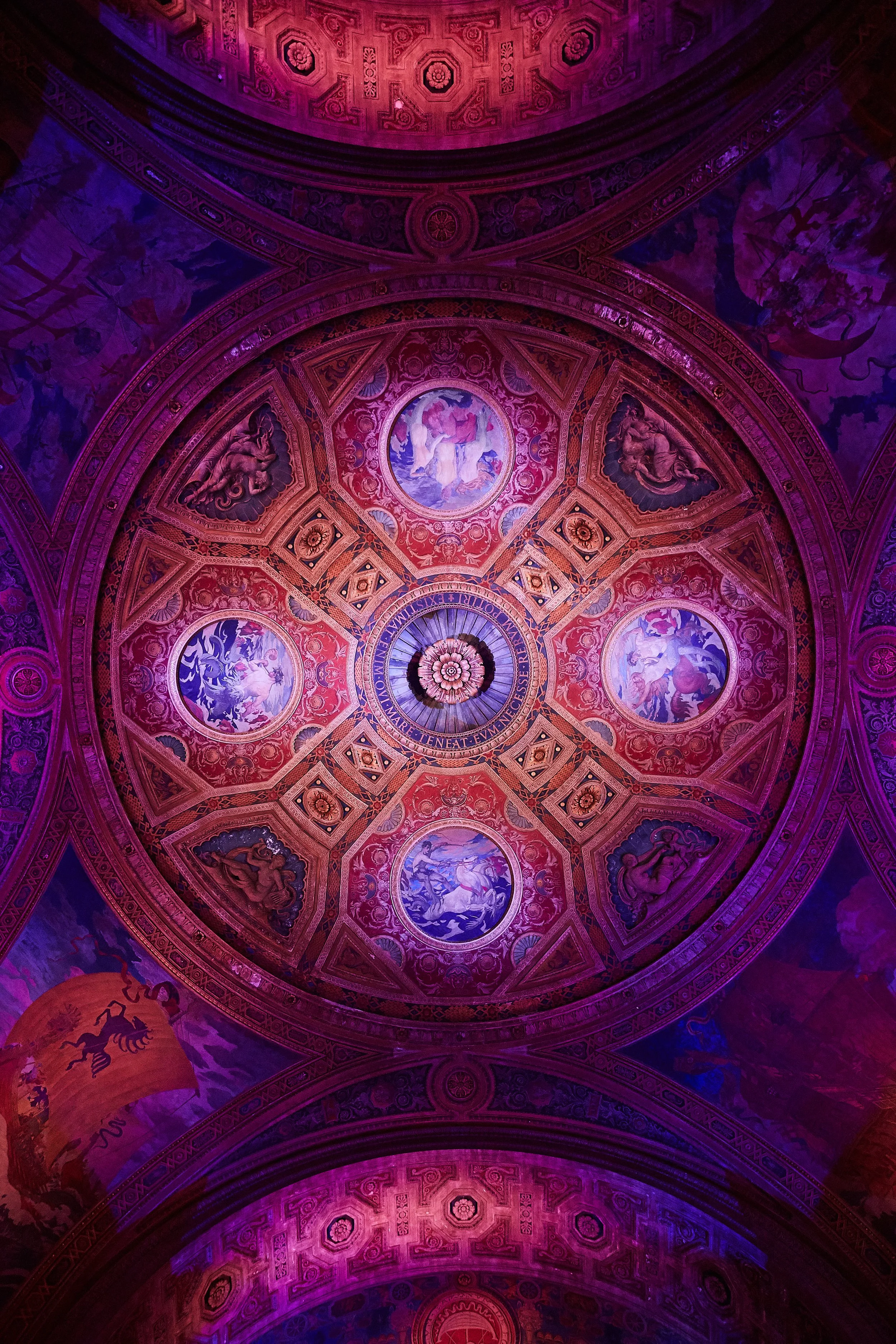 Ornate domed ceiling at Cipriani Wall Street in New York City illuminated for a Bar Mitzvah — intricate architectural details enhanced with vibrant lighting, creating a dramatic and immersive atmosphere overhead.