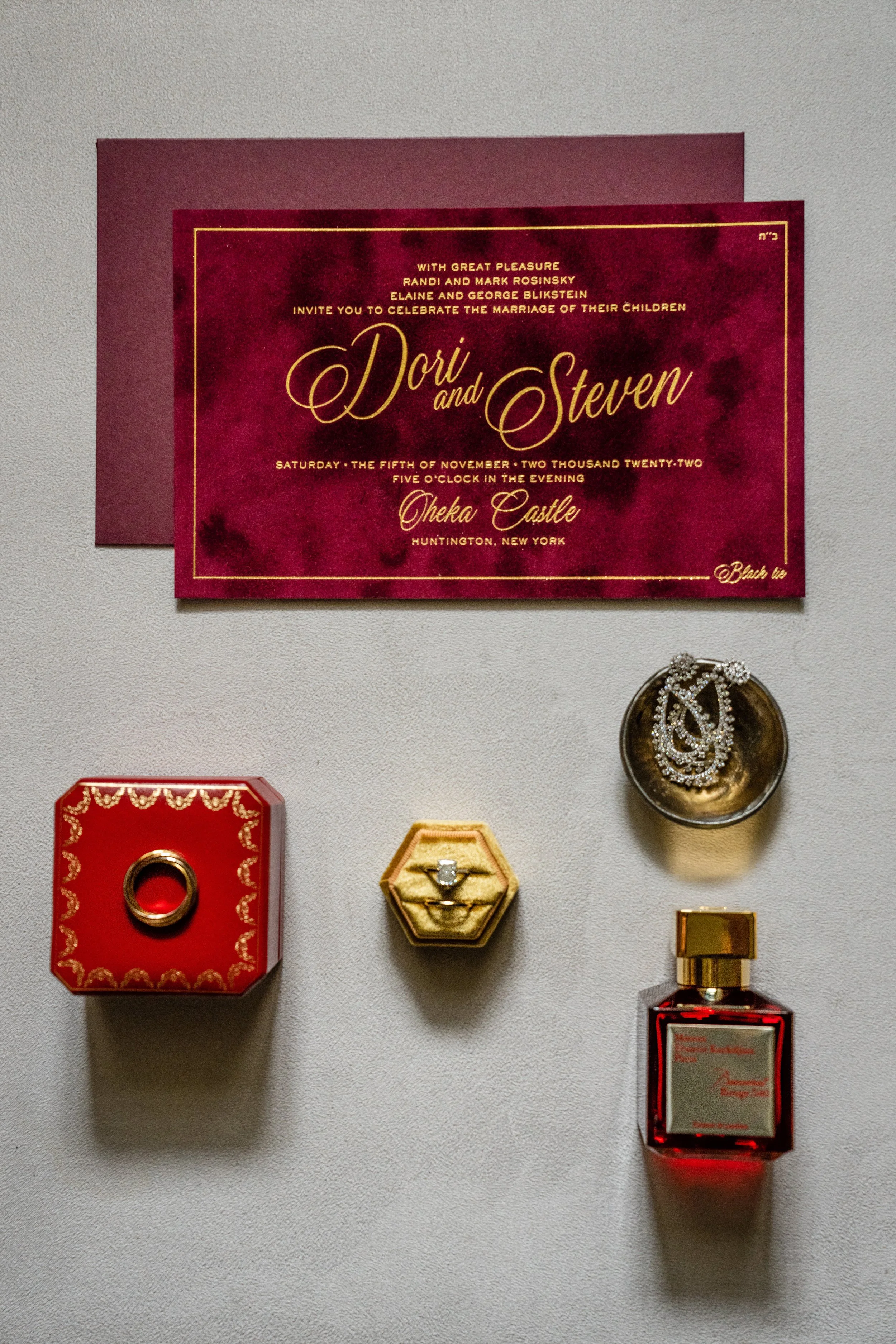 Red velvet wedding invitation with gold lettering. 