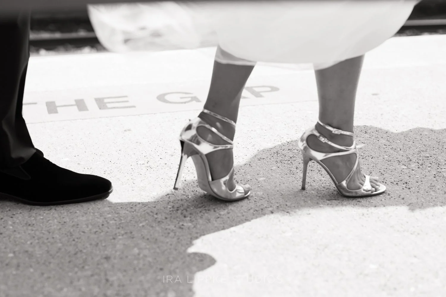 A stylish close-up of the bride’s heels and gown, highlighting the fashion-forward details that completed her wedding day look.