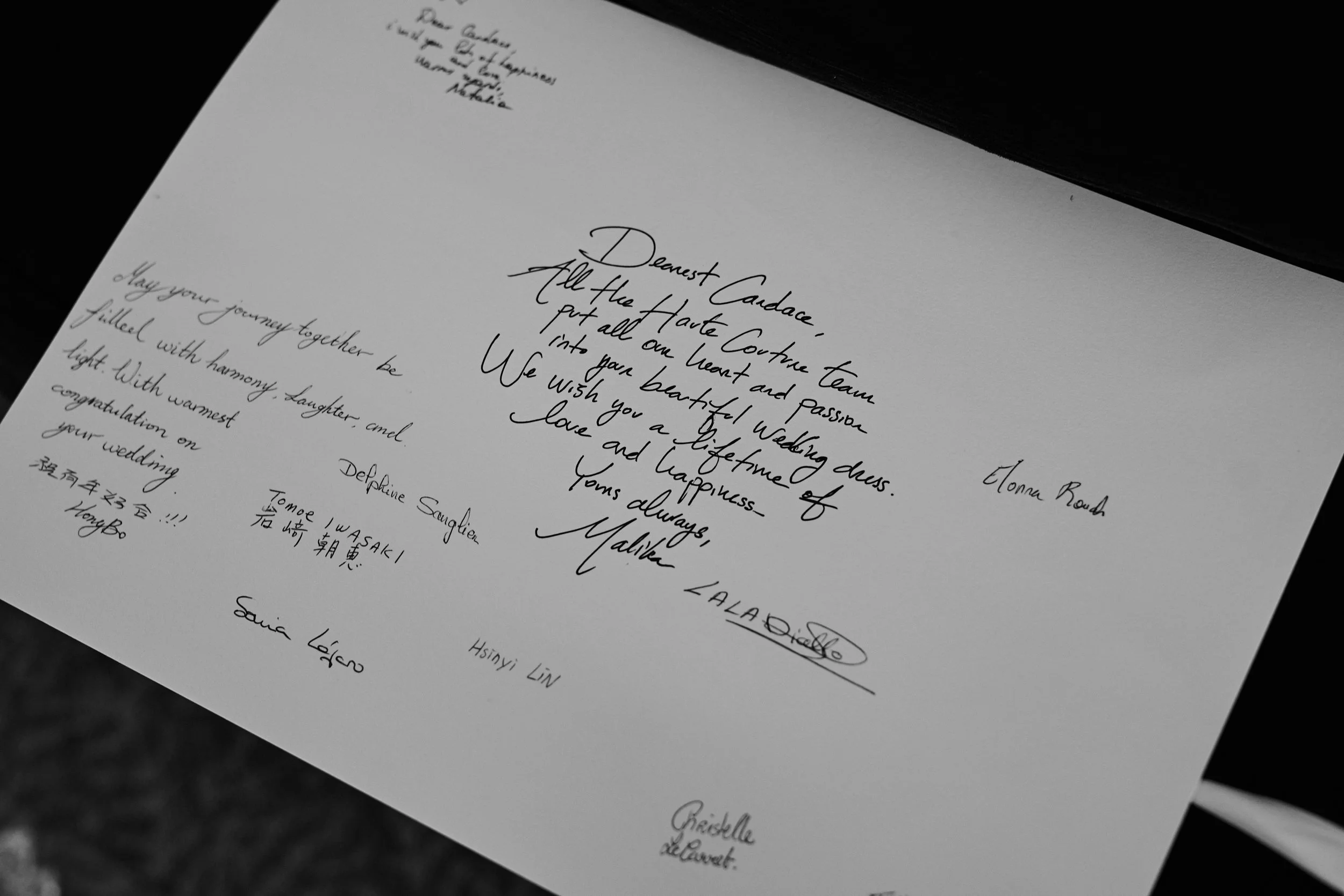 A signed letter from the Christian Dior Paris atelier, offering a rare glimpse into the craftsmanship behind the bride’s custom gowns—an intimate and deeply personal detail.
